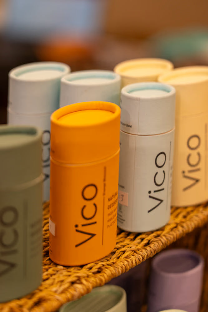 Orange deodorant container with 'Vico' branding on a white background
