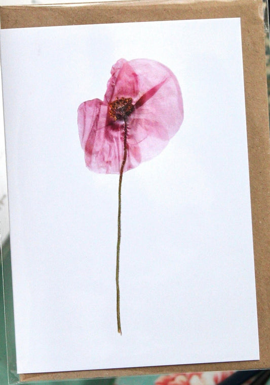 White card with a pink flower design with a brown envelope