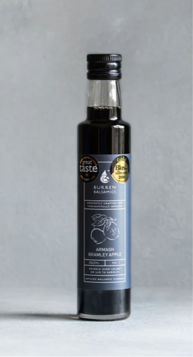 Bottle of balsamic vinegar with a label on a gray background