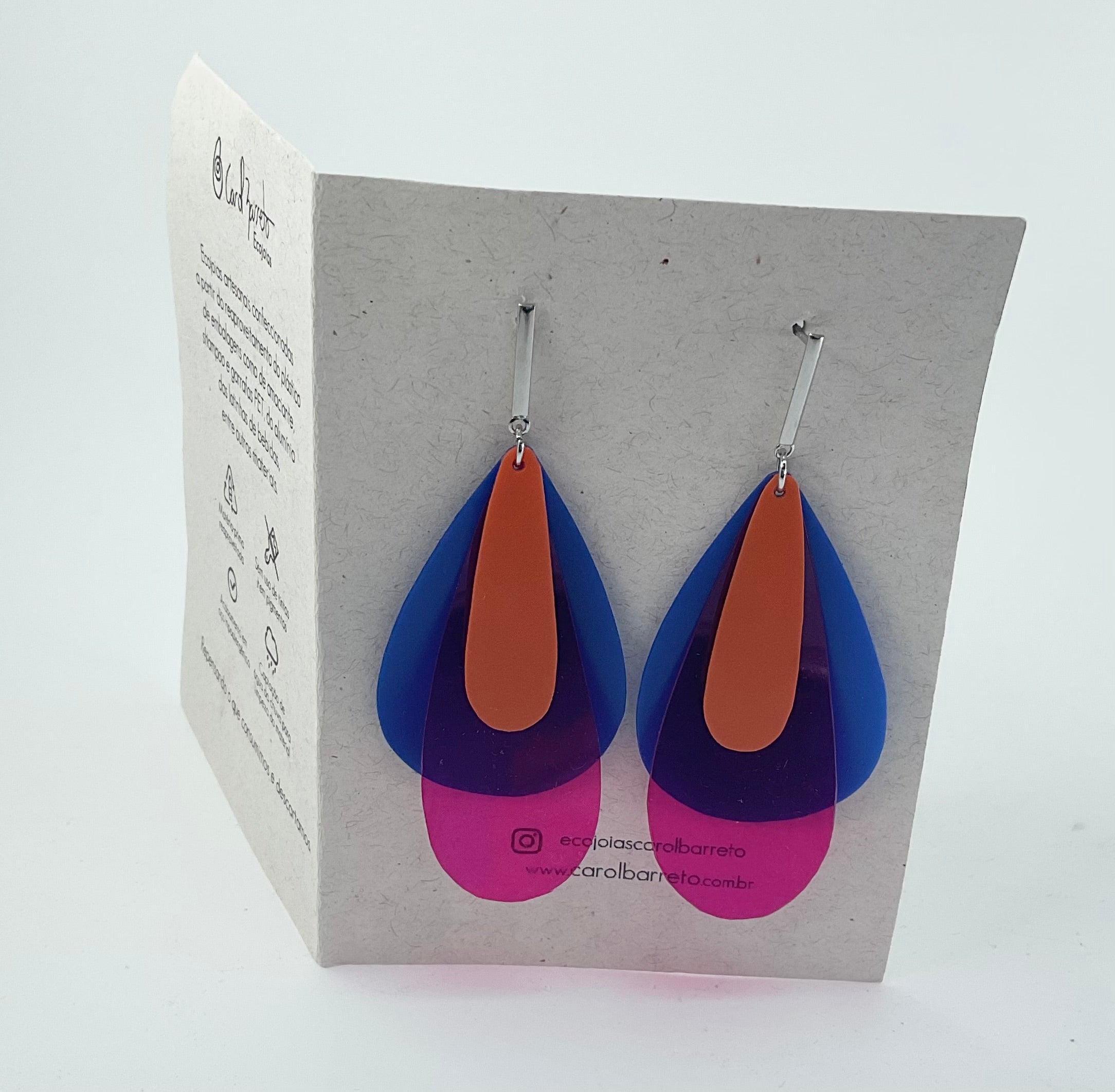 Colorful teardrop-shaped earrings on a display card with branding.
