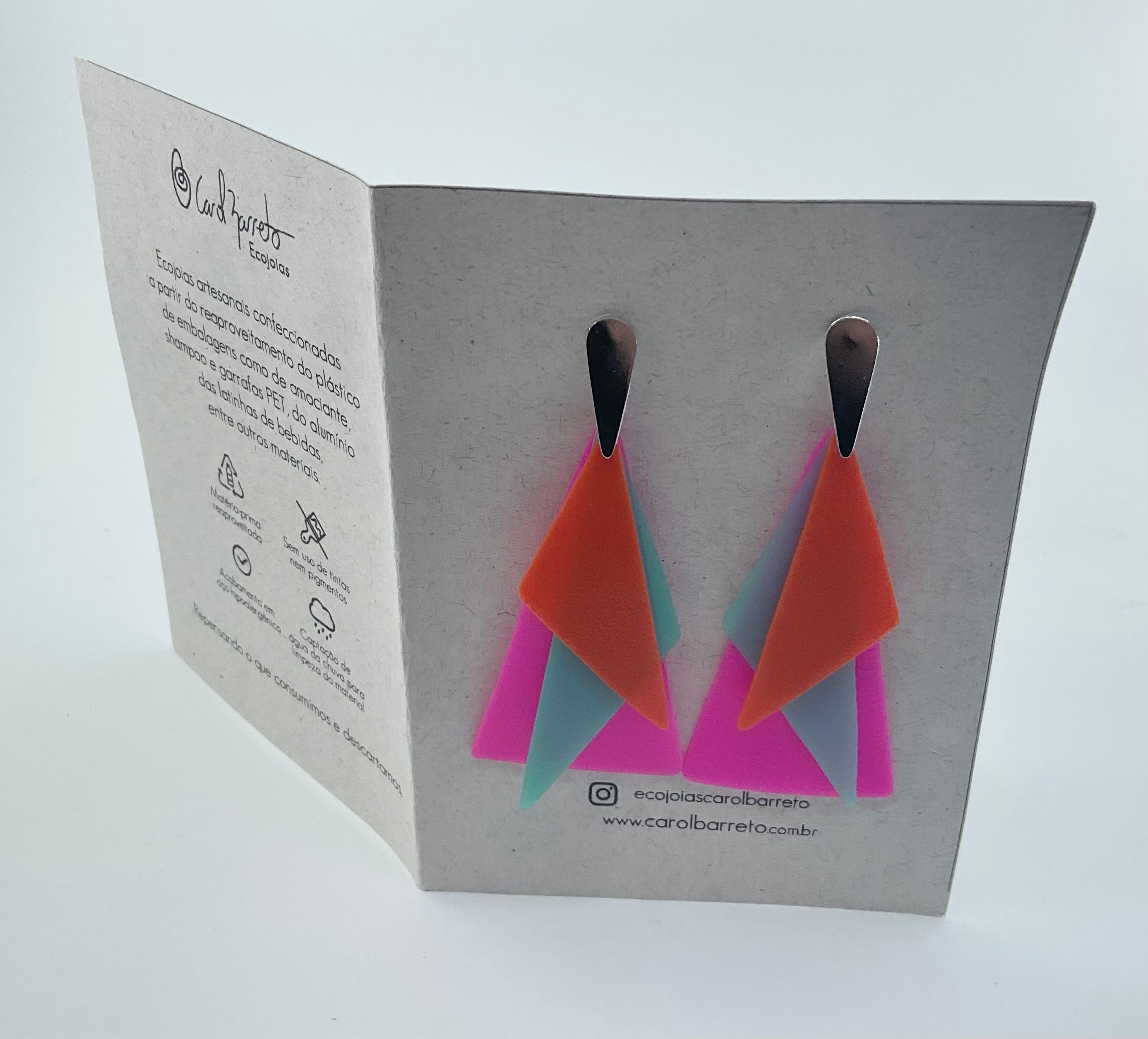 Geometric earrings on a branded card with a white background