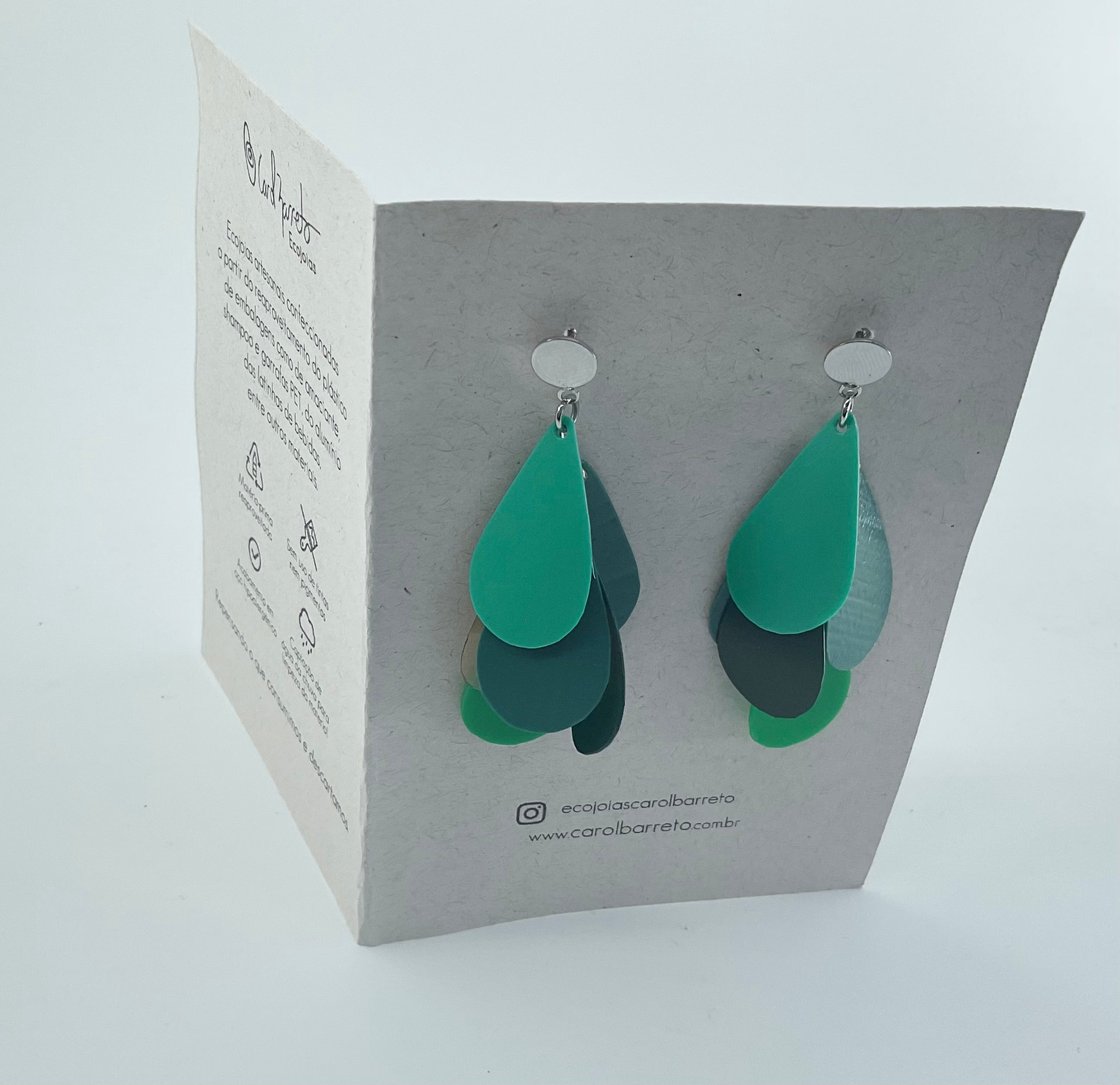 Green teardrop-shaped earrings on a branded card with a white background