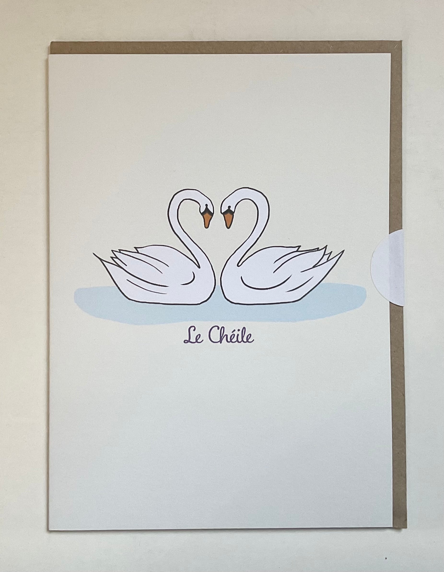 Card with two swans forming a heart on a light background, featuring the brand 'Le Chéète'.