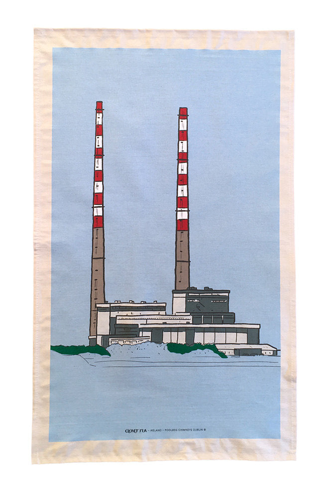 Tea towel with a graphic of two tall red and white chimneys against a blue sky.