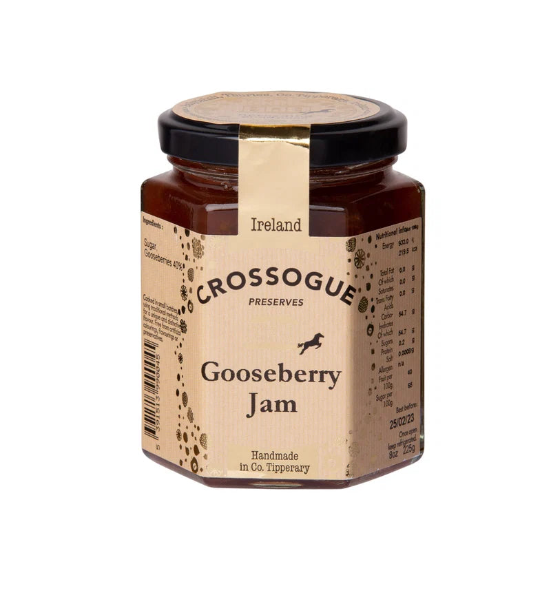 A hexagonal glass jar of Crossogue Preserves Gooseberry Jam with a black lid and a beige paper label, shown on a plain white background.