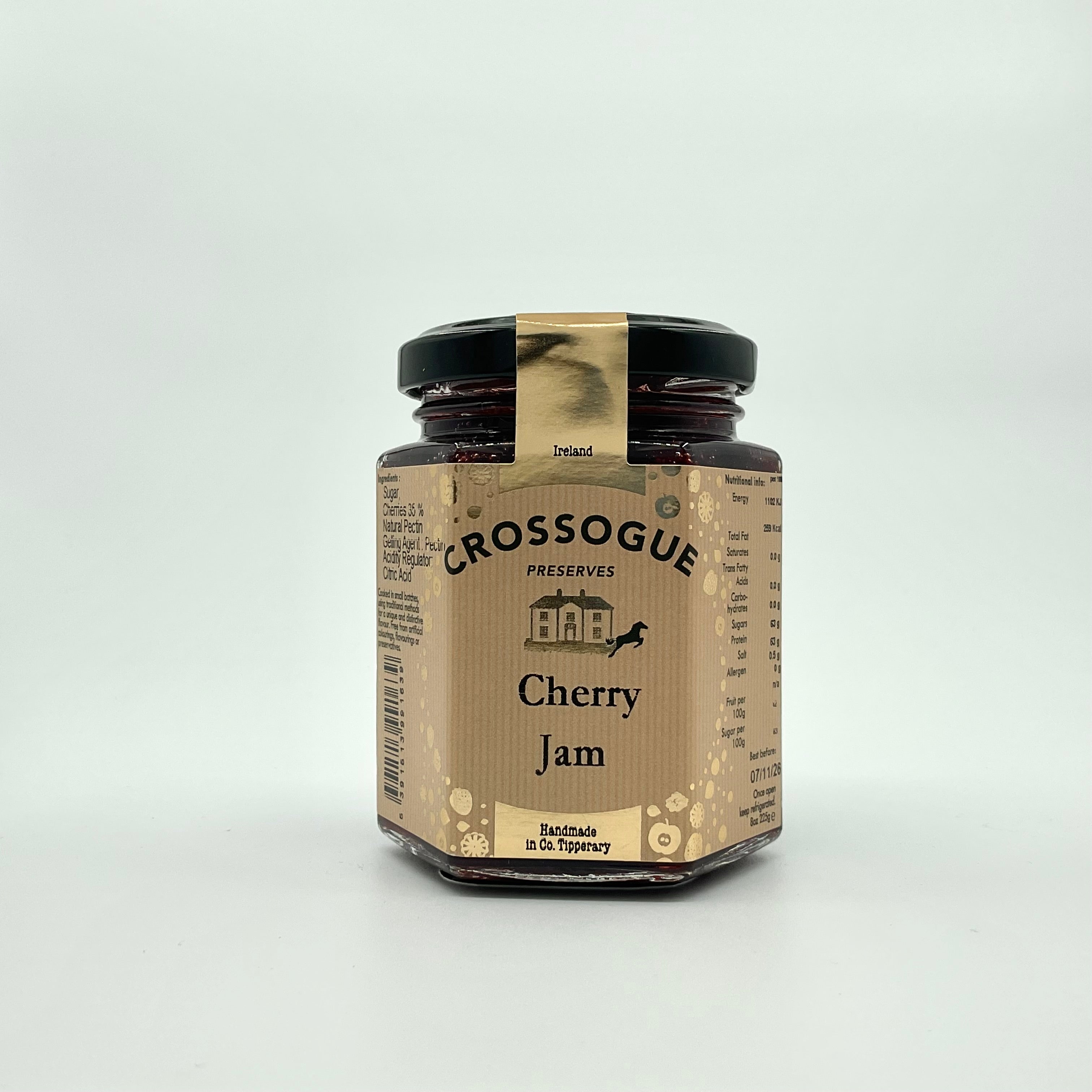 A jar of Crossogue Cherry Jam with a label that includes the brand name, product title, and additional information, set against a white background.