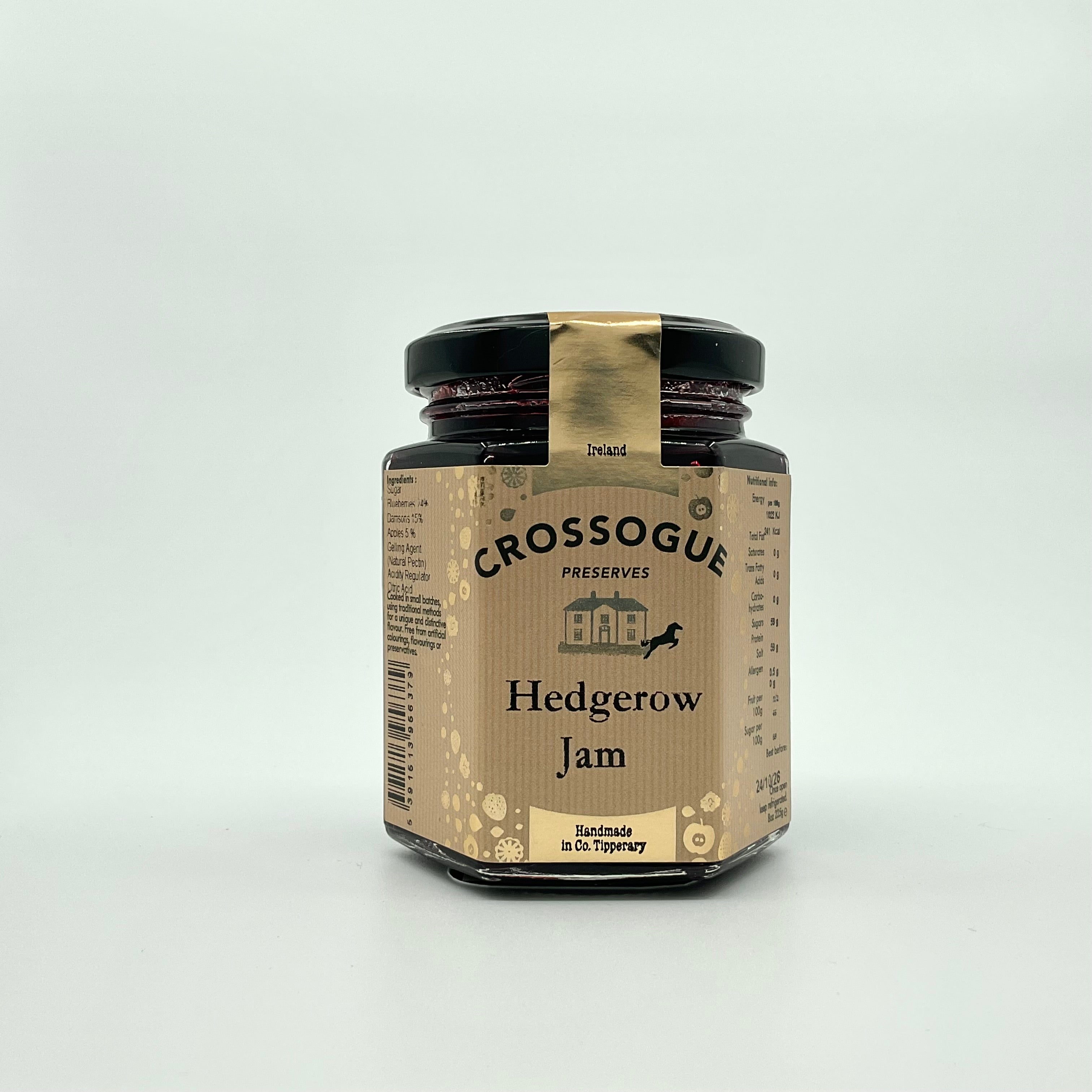 A jar of Crossogue Hedgerow Jam with a label that includes the product name and a brief description, set against a white background.