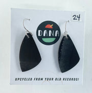 Black earrings on a card with 'Dana' branding and text about upcycling from records.