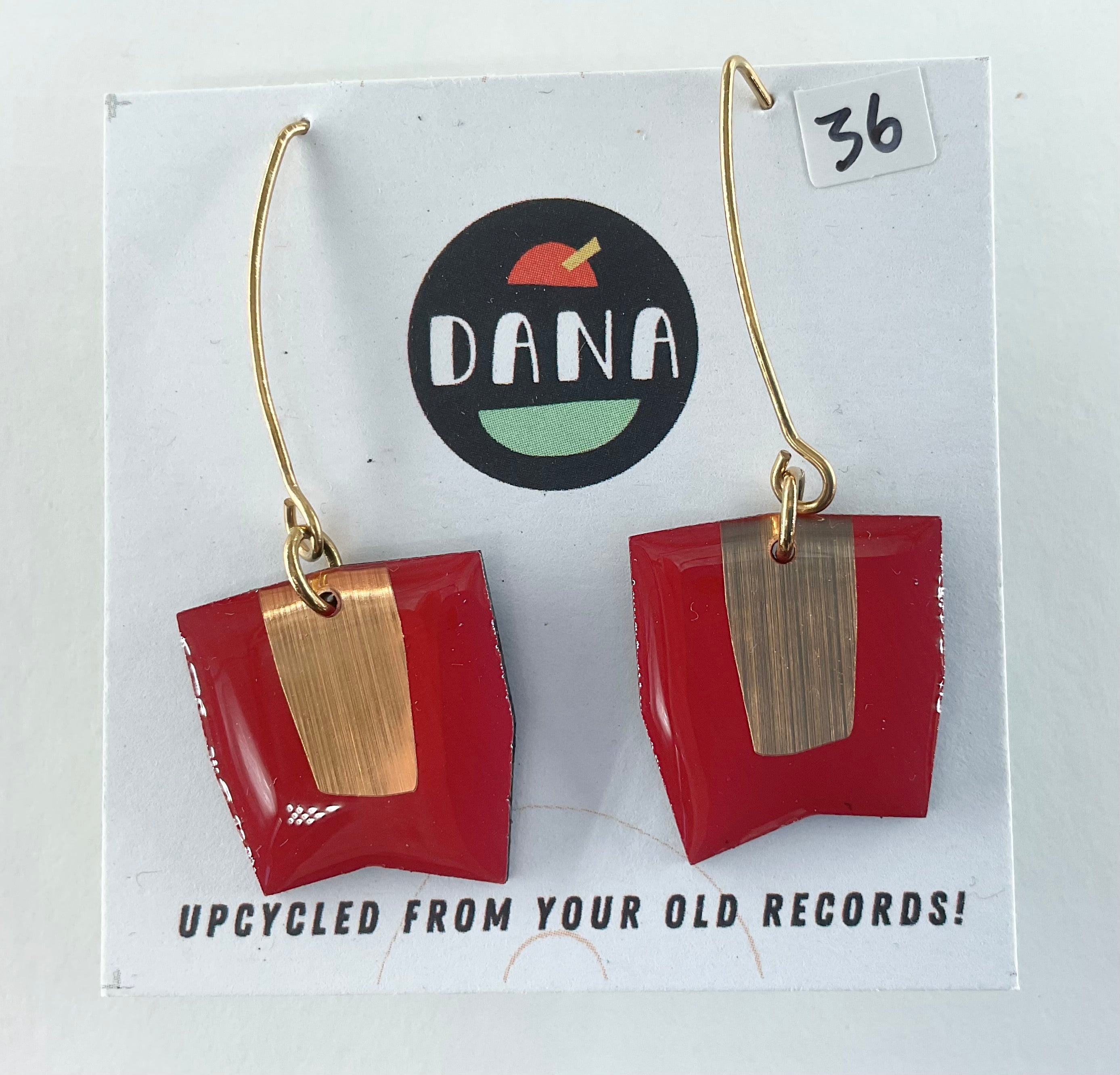 Red and gold earrings on a DANA branded card with text 'Upcycled from your old records!'.