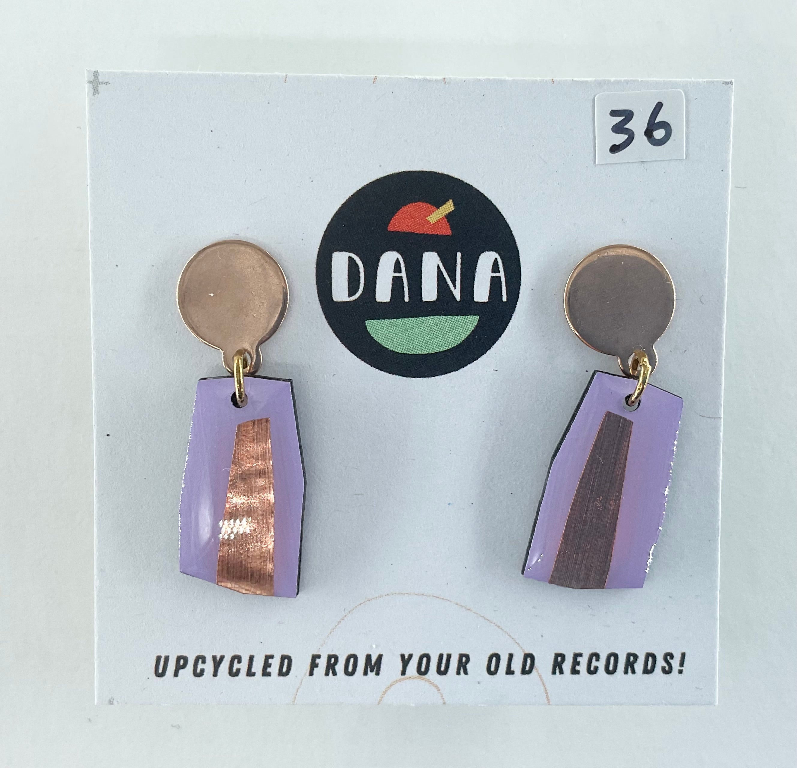 Earrings on a card with 'DANA' branding and upcycling information.