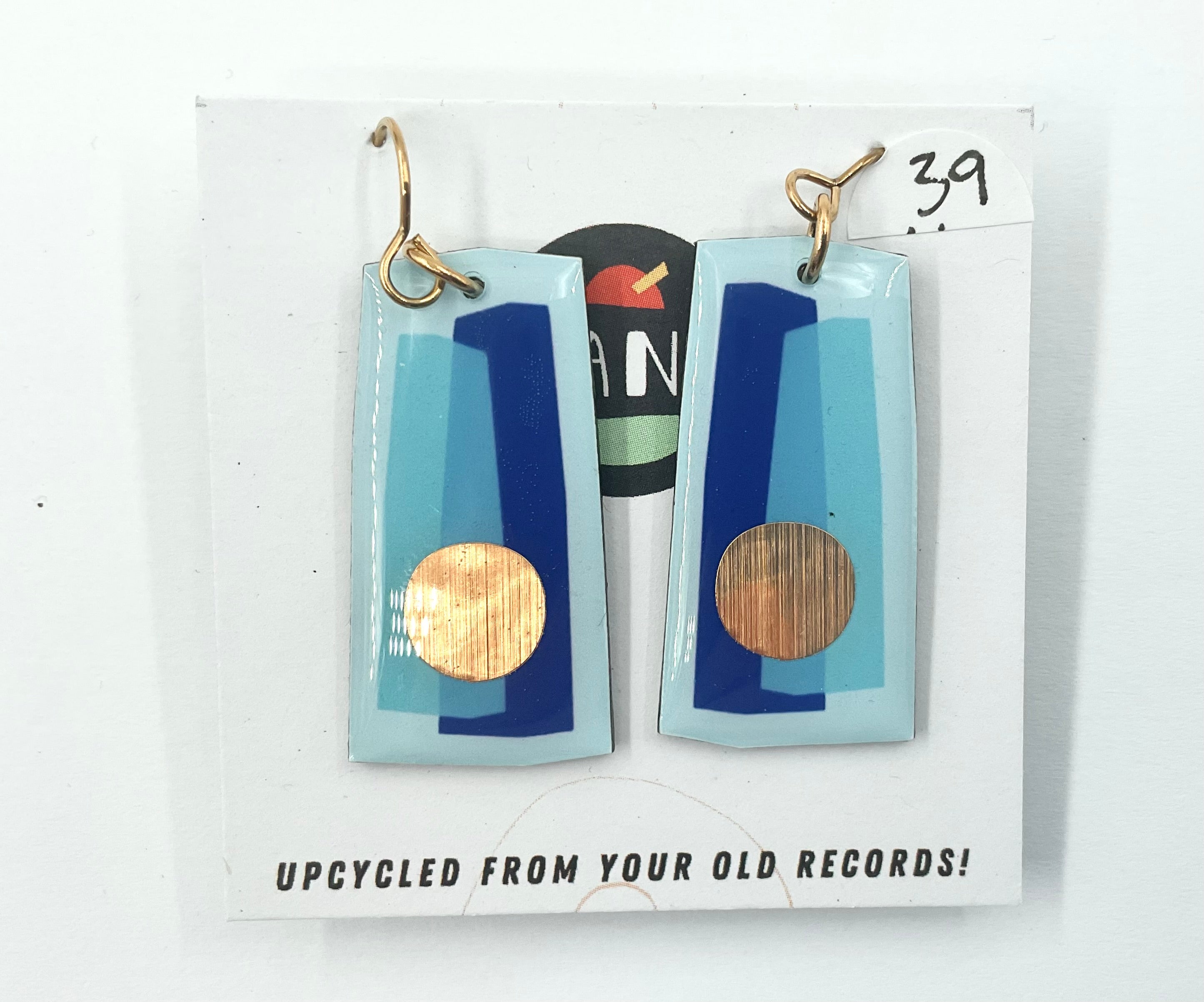 A pair of earrings made from upcycled vinyl records, predominantly blue with gold circular details, displayed on a white card with the text 'UPCYCLED FROM YOUR OLD RECORDS!' and the number '39'.