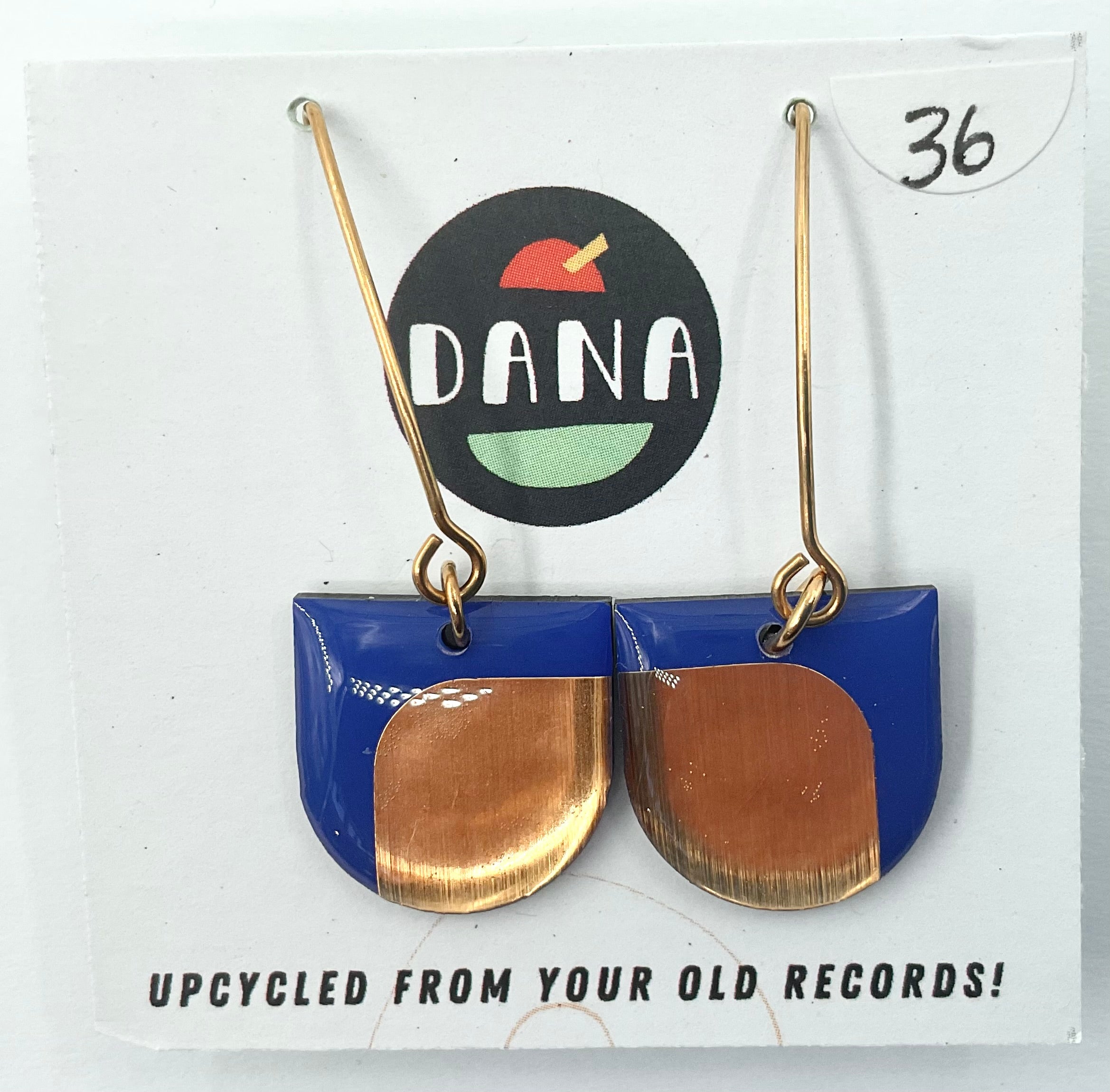 A pair of blue and metallic earrings, with the brand name Dana, displayed on a white background with a label indicating they are upcycled from old records.