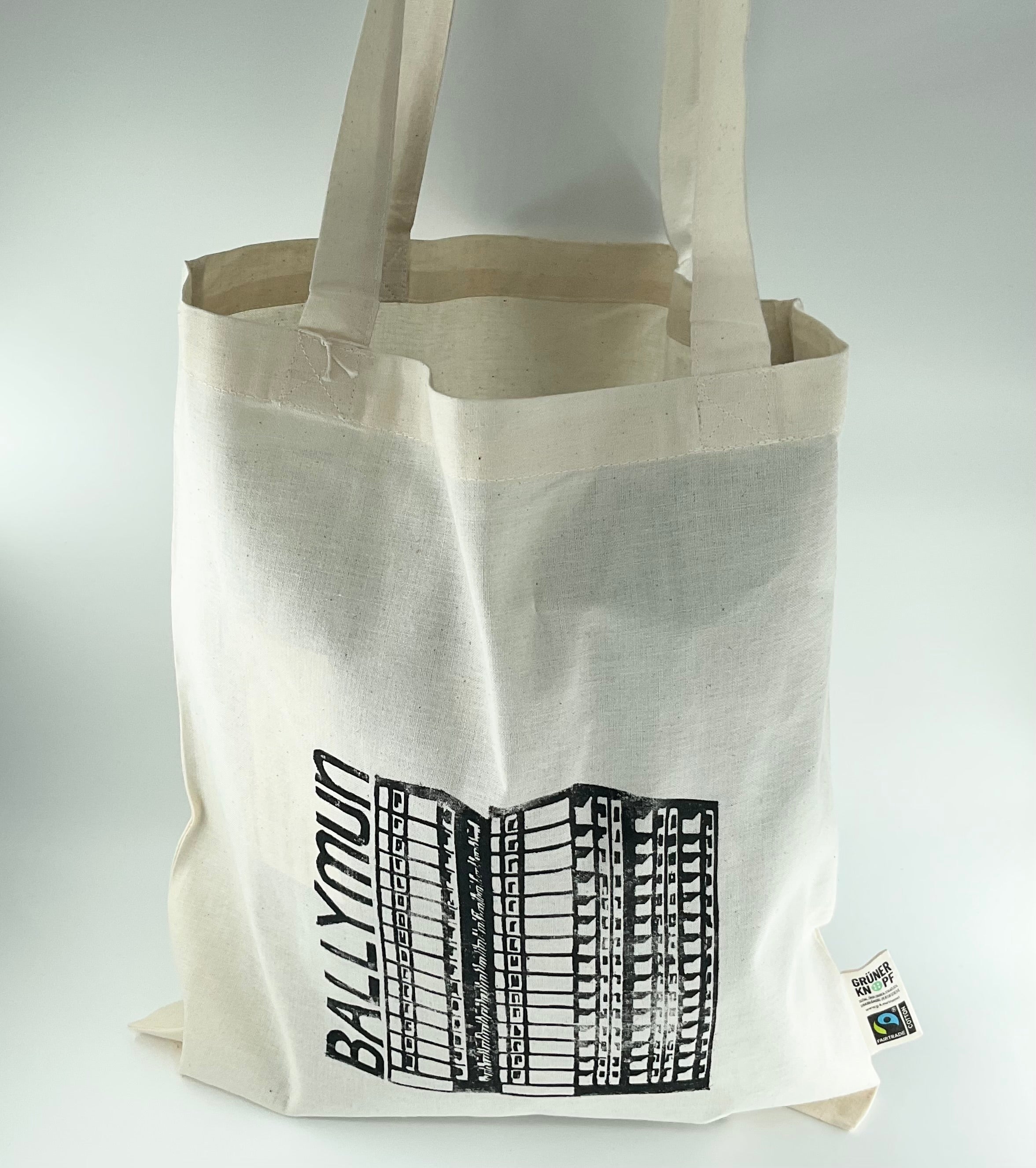 Beige tote bag with black graphic design and 'Ballymun' text on a white background