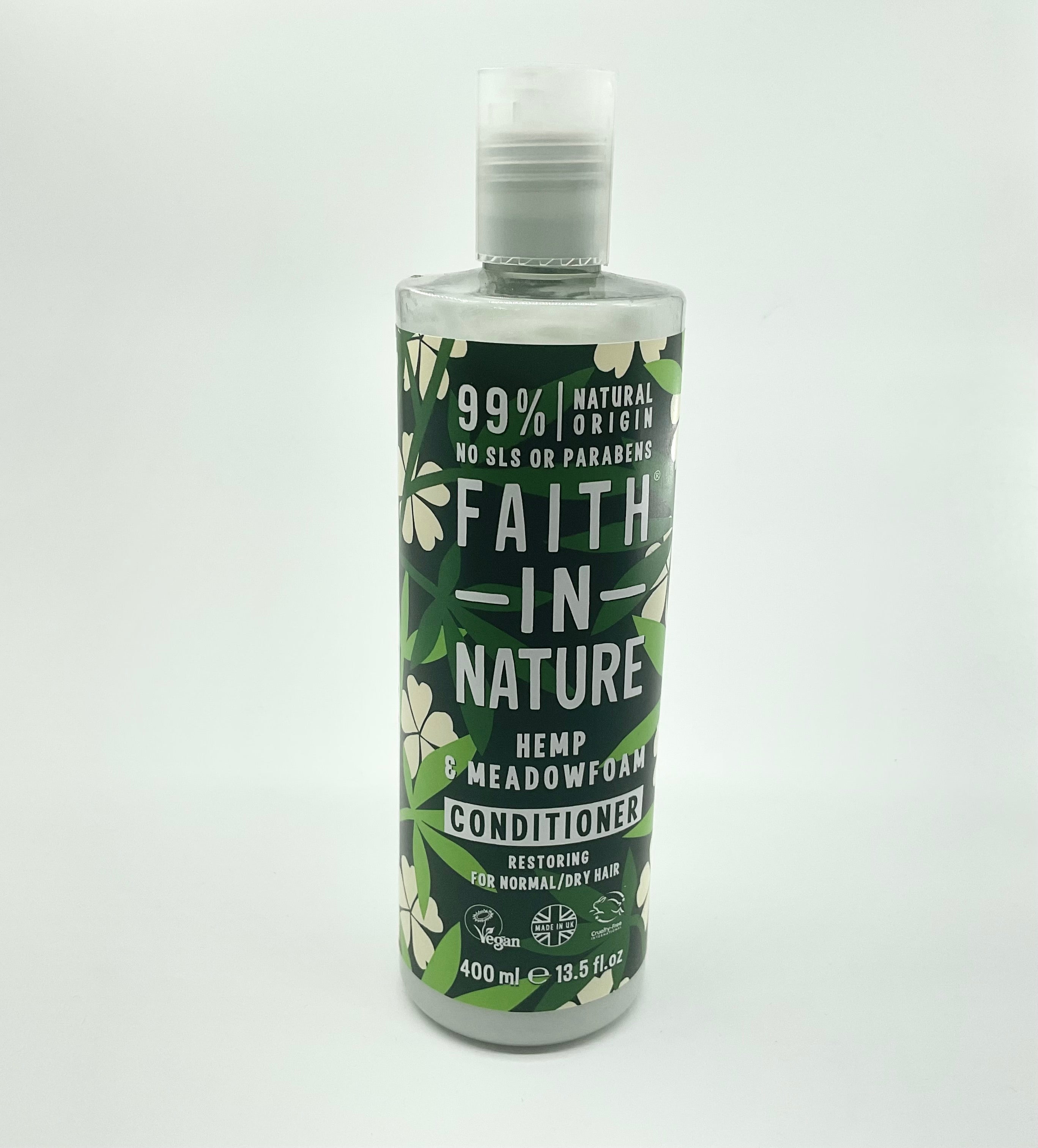 A bottle of FAITH IN NATURE Hemp & Meadowfoam Conditioner, 400 ml. Packaging is predominantly green with floral patterns and product information text.