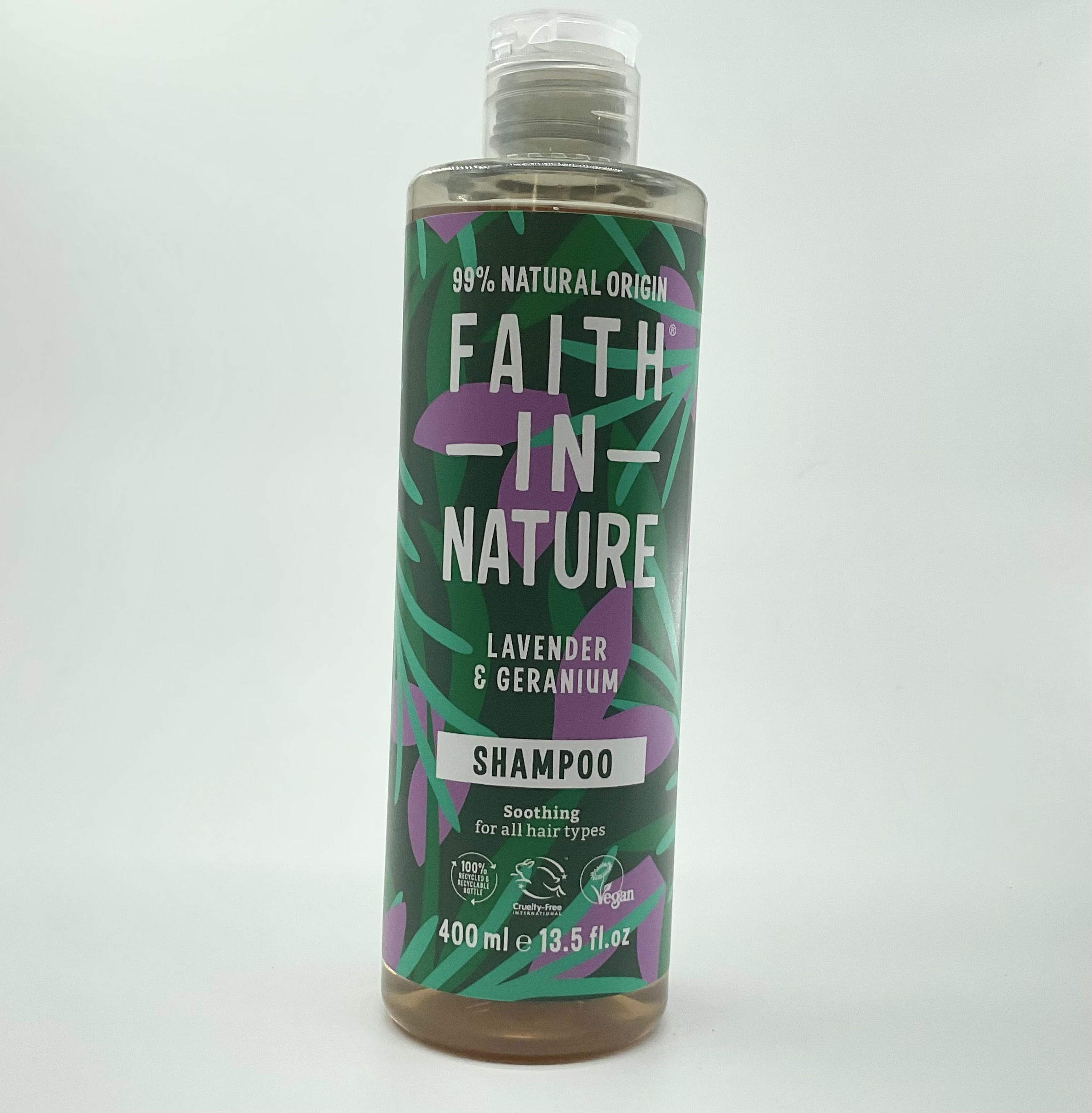 A bottle of FAITH IN NATURE Lavender & Geranium Shampoo with a green and purple label, indicating it is a 400 ml product.