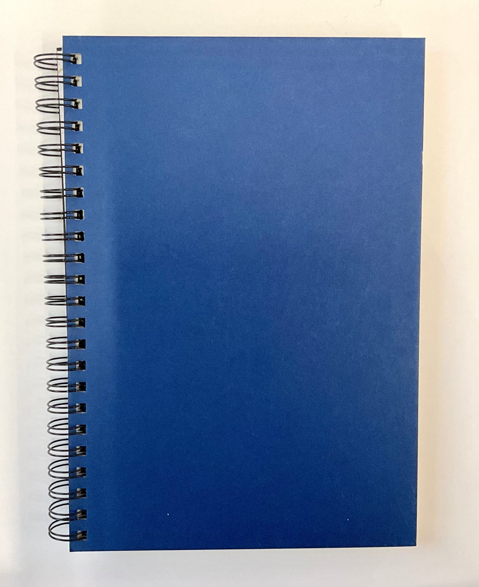 Blue spiral-bound notebook on a white background