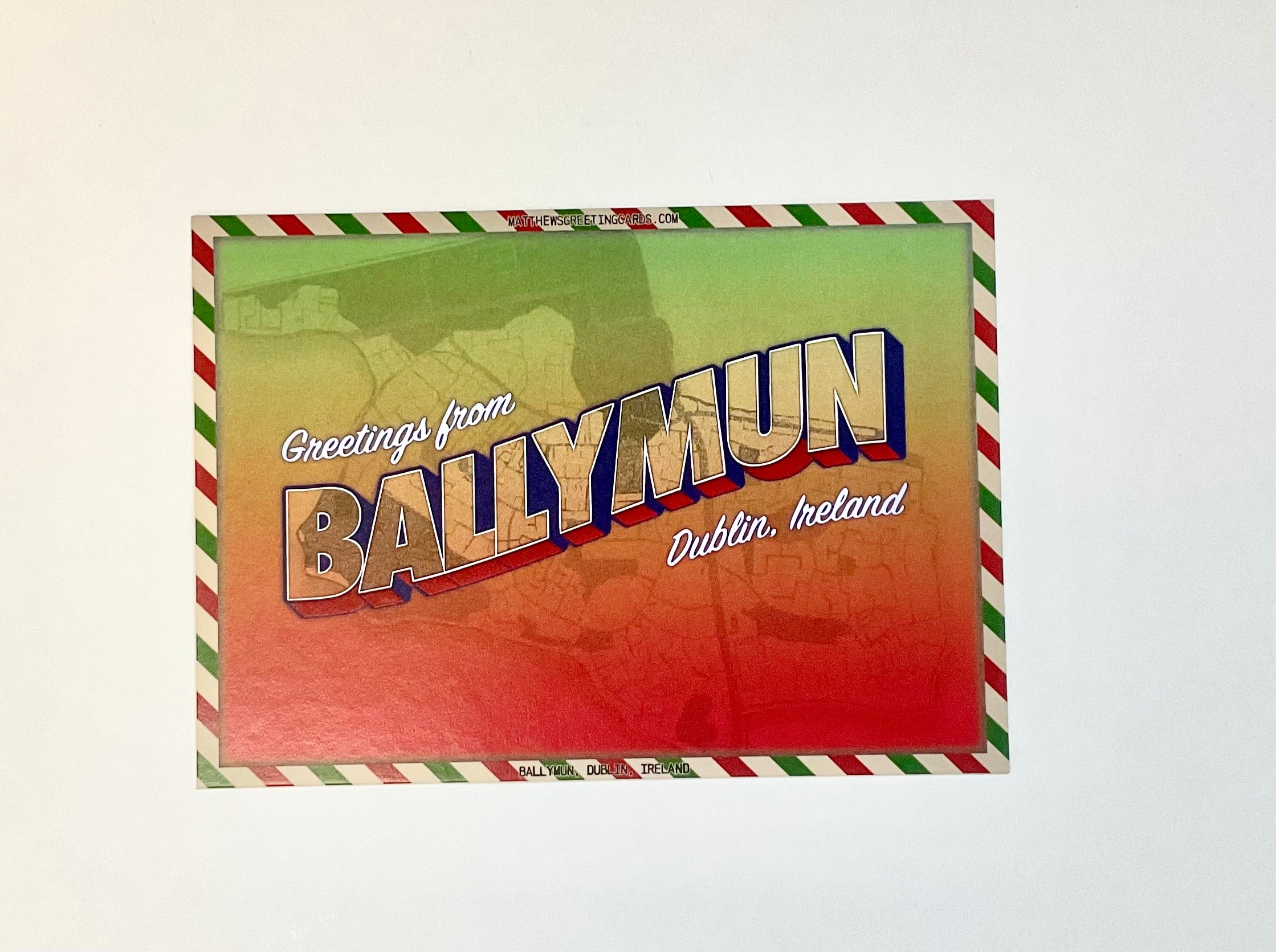 Vintage-style postcard with 'Greetings from Ballymun, Dublin, Ireland' text on a colorful background.