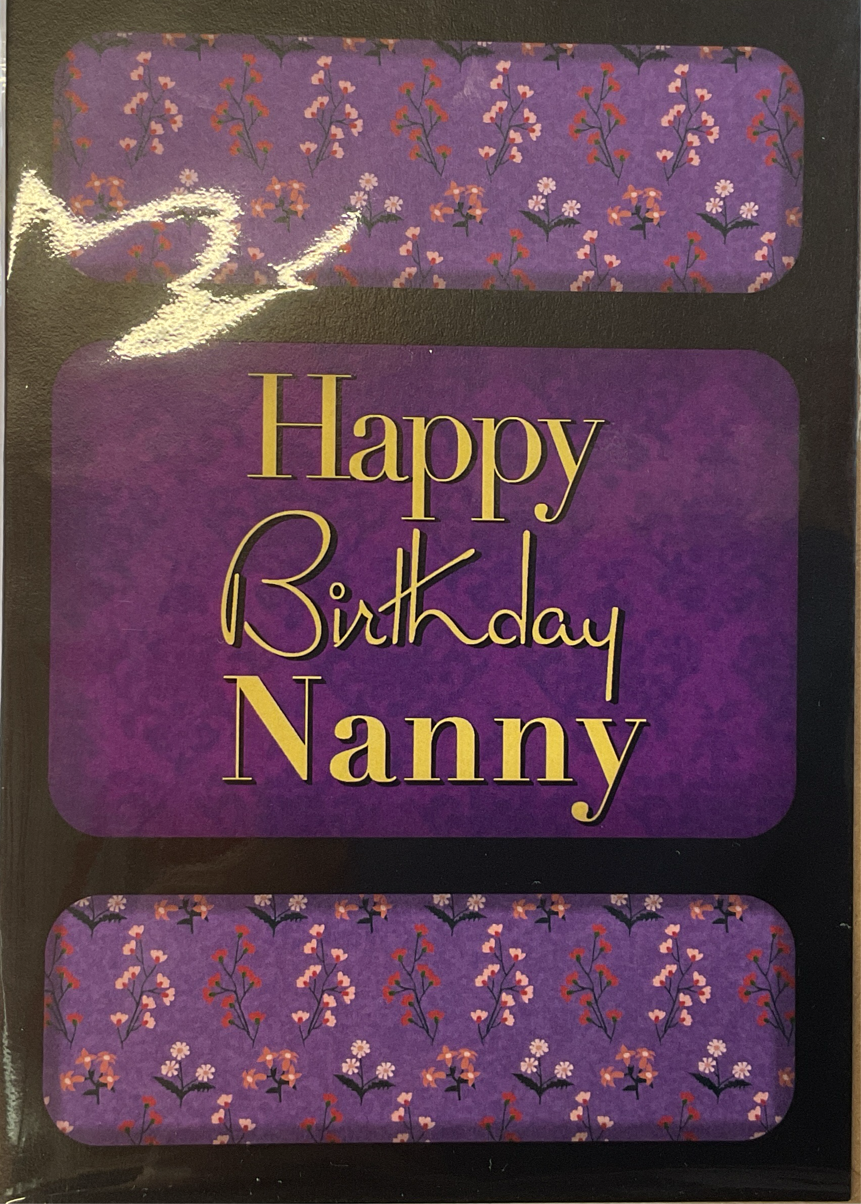 Greeting card with purple background and floral patterns around the text 'Happy Birthday Nanny'.