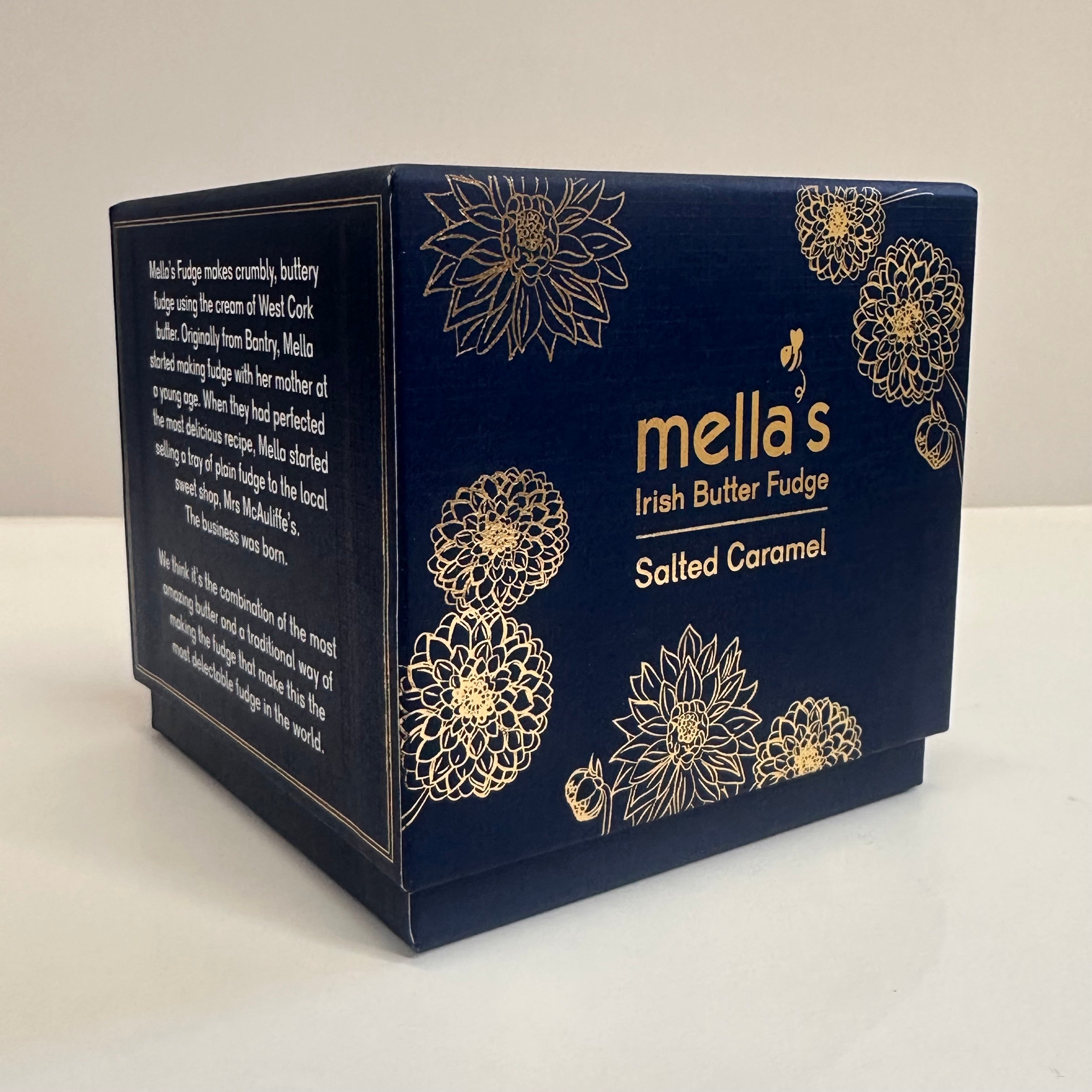 Navy blue packaging of mella's Irish Butter Fudge with gold floral designs on a white background