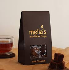 Mella's Irish Butter Fudge packaging with fudge pieces on a wooden surface