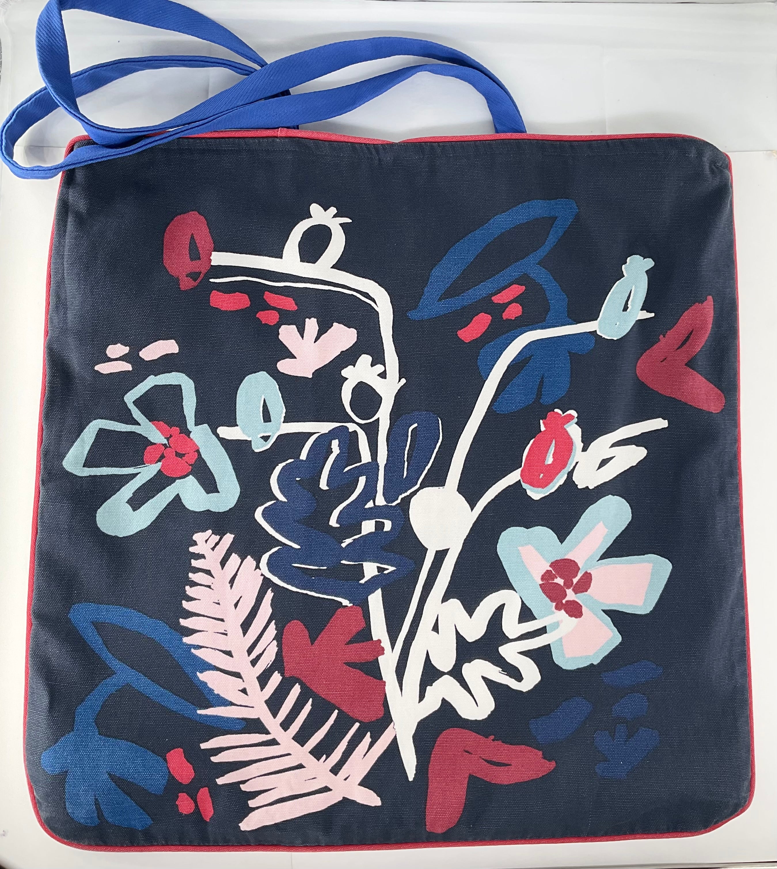 Navy blue bag with colorful floral design on a white background