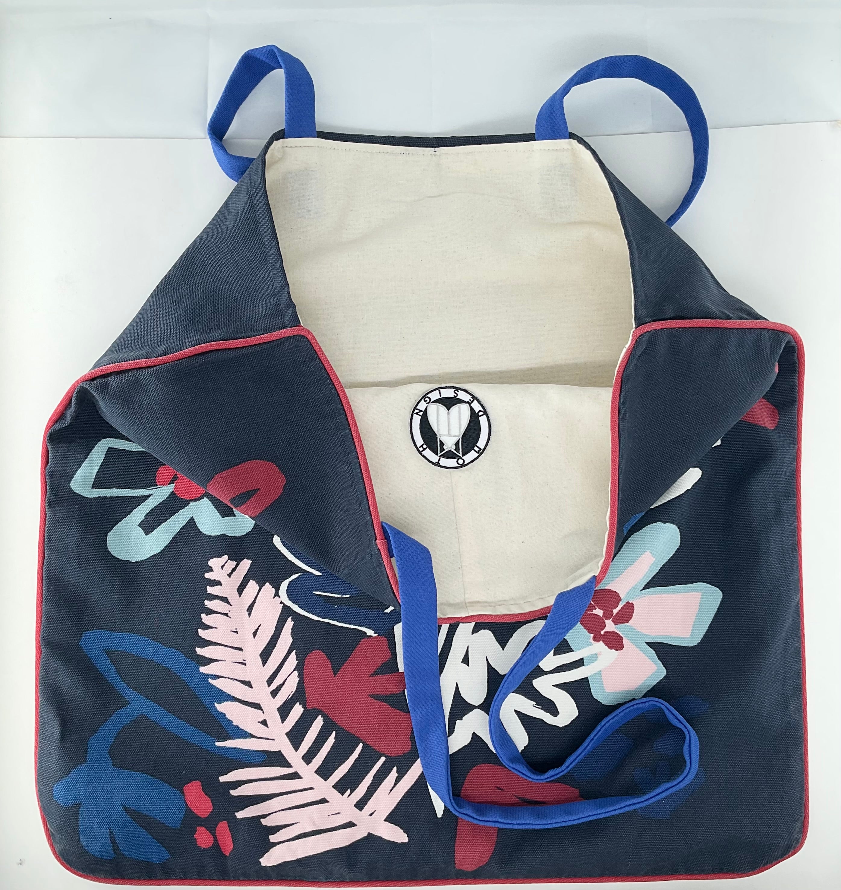 Navy blue bag with floral patterns and a logo on a white background