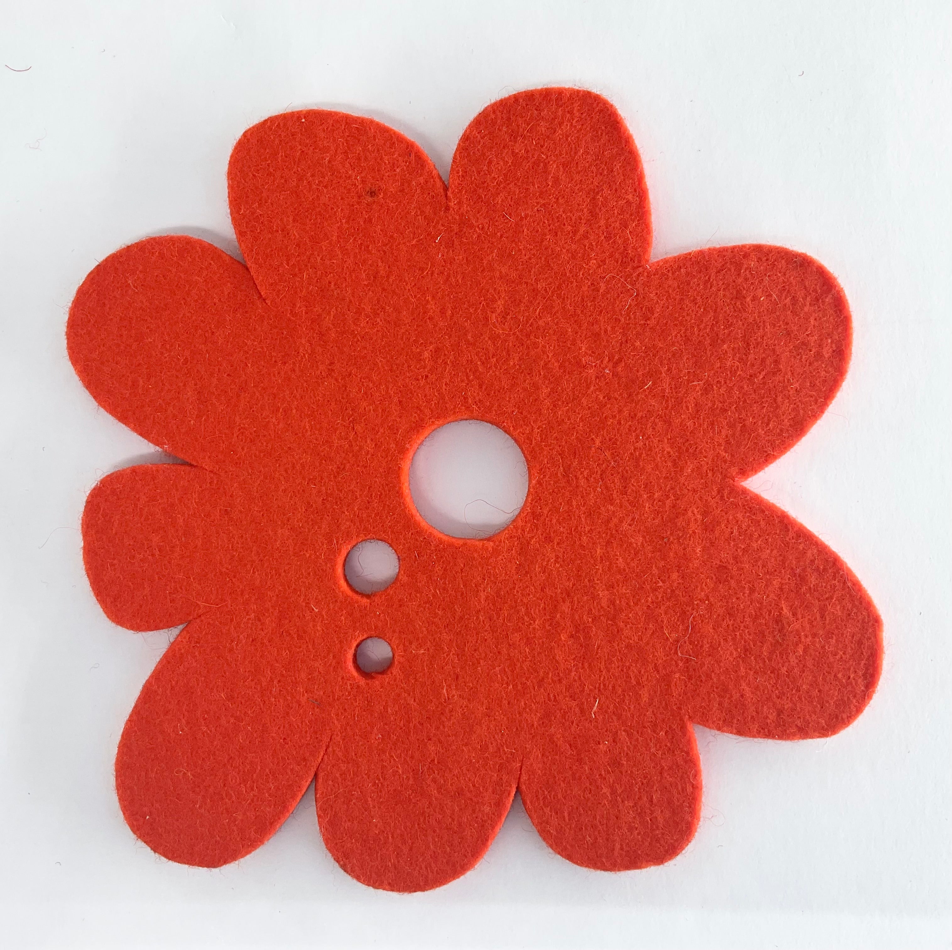 Red flower-shaped pot stand on a white background