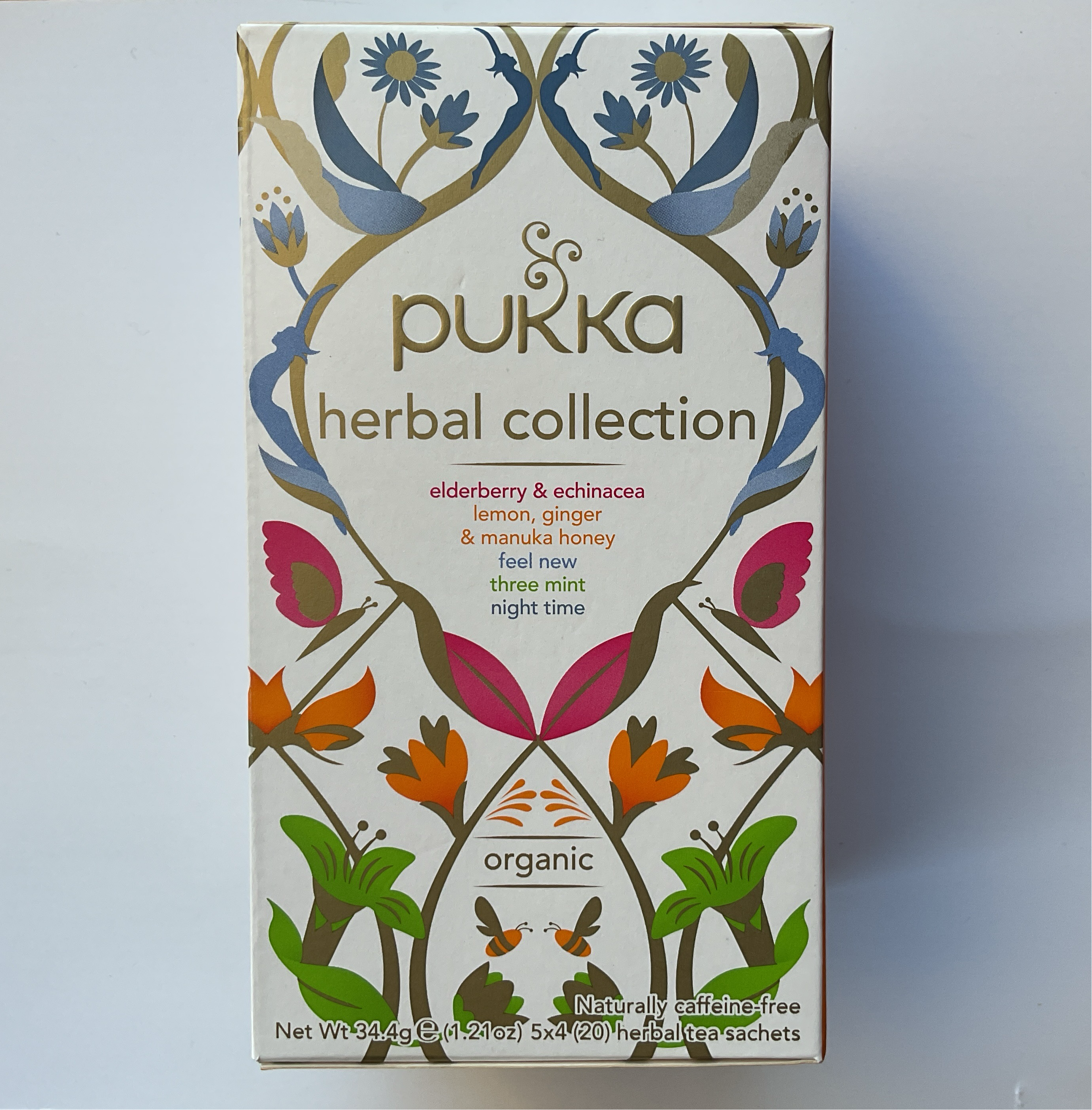 Packaging of Pukka Herbal Collection featuring various herbal tea blends, with colorful botanical design and 'organic' label.