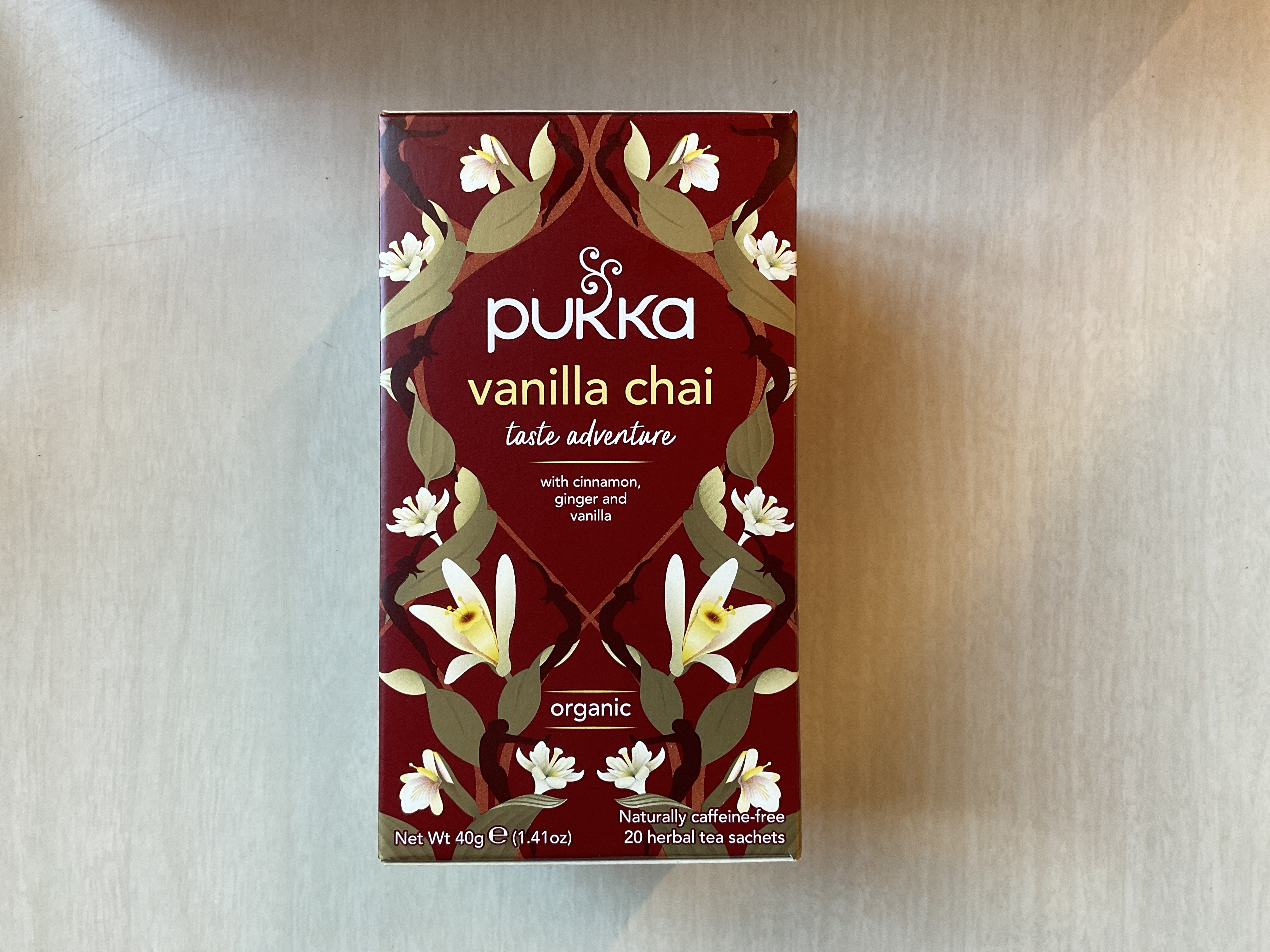 A box of Pukka Vanilla Chai Taste Adventure tea with a floral and spice design on the packaging.