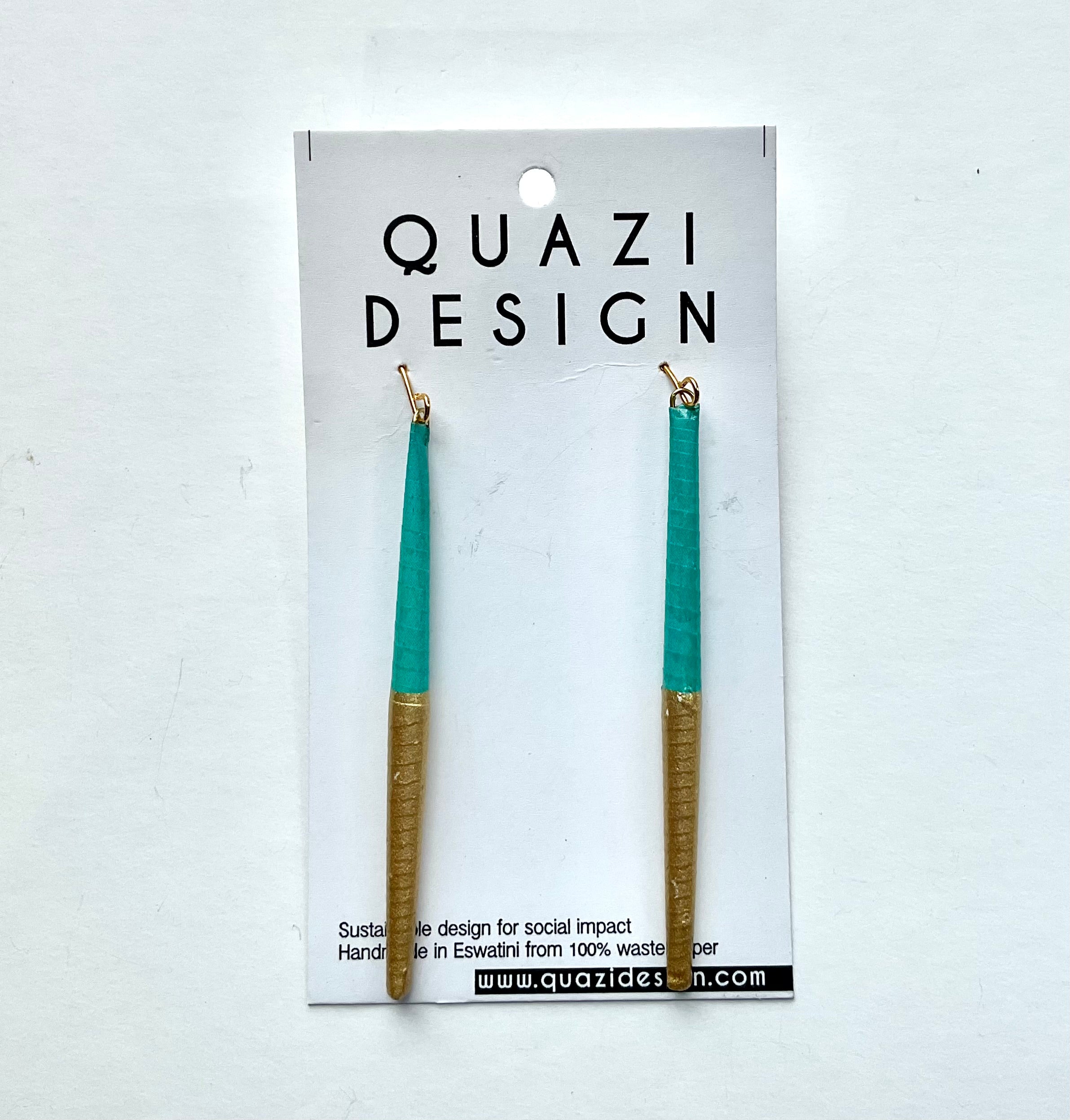 Teal and gold earrings on a Quazi Design card against a white background