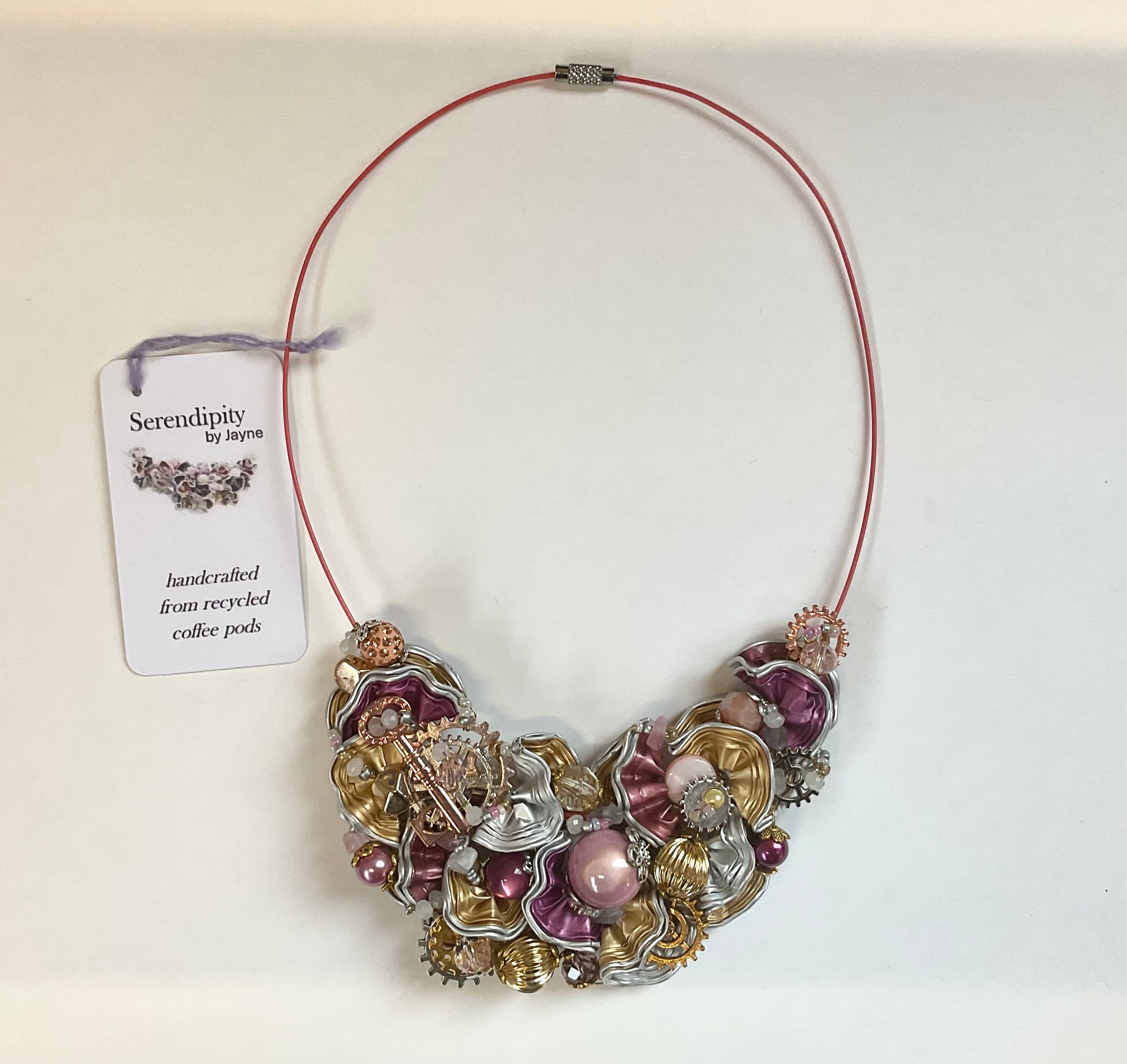 Necklace made from recycled coffee pods on a white background