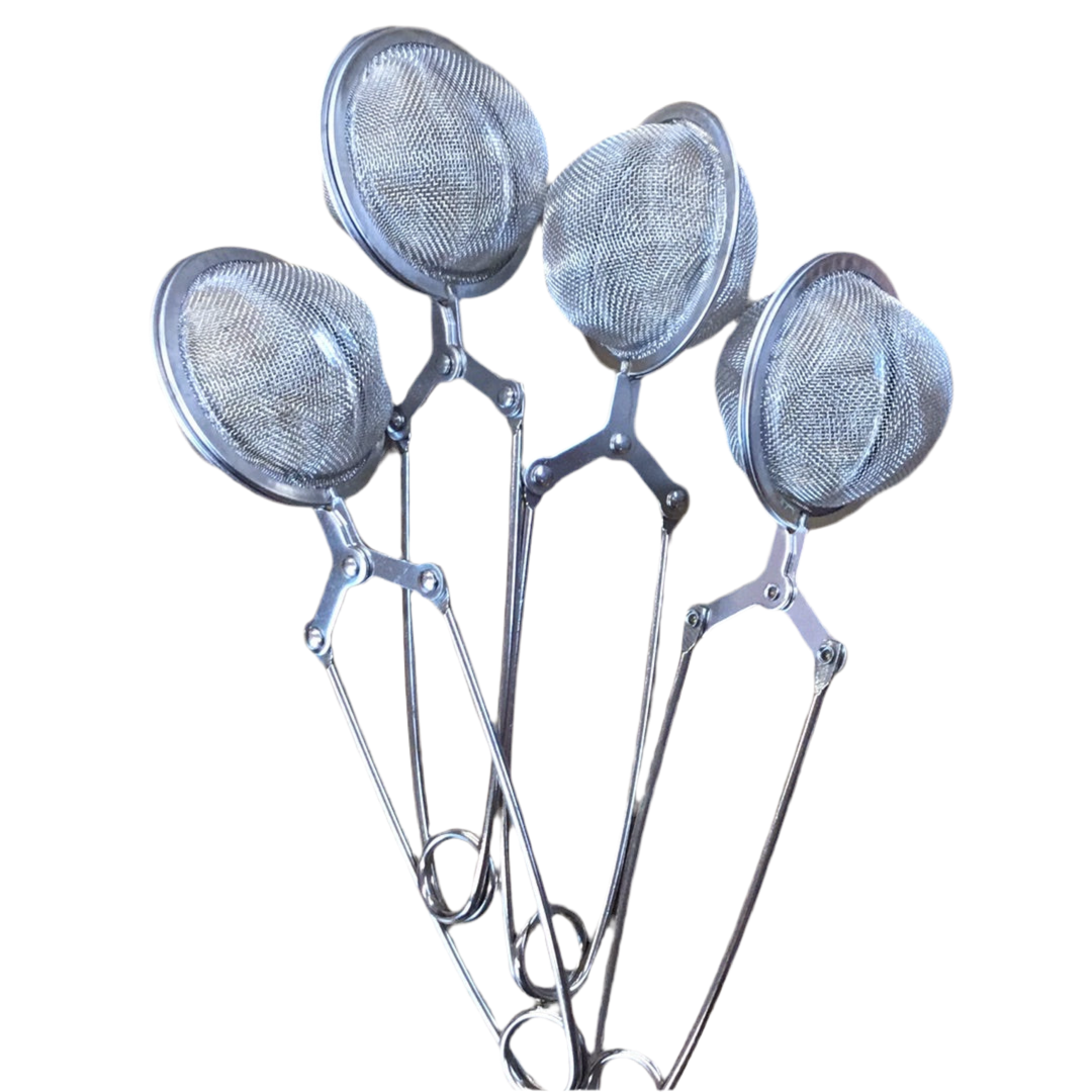 Set of four metal tea infusers on a white background
