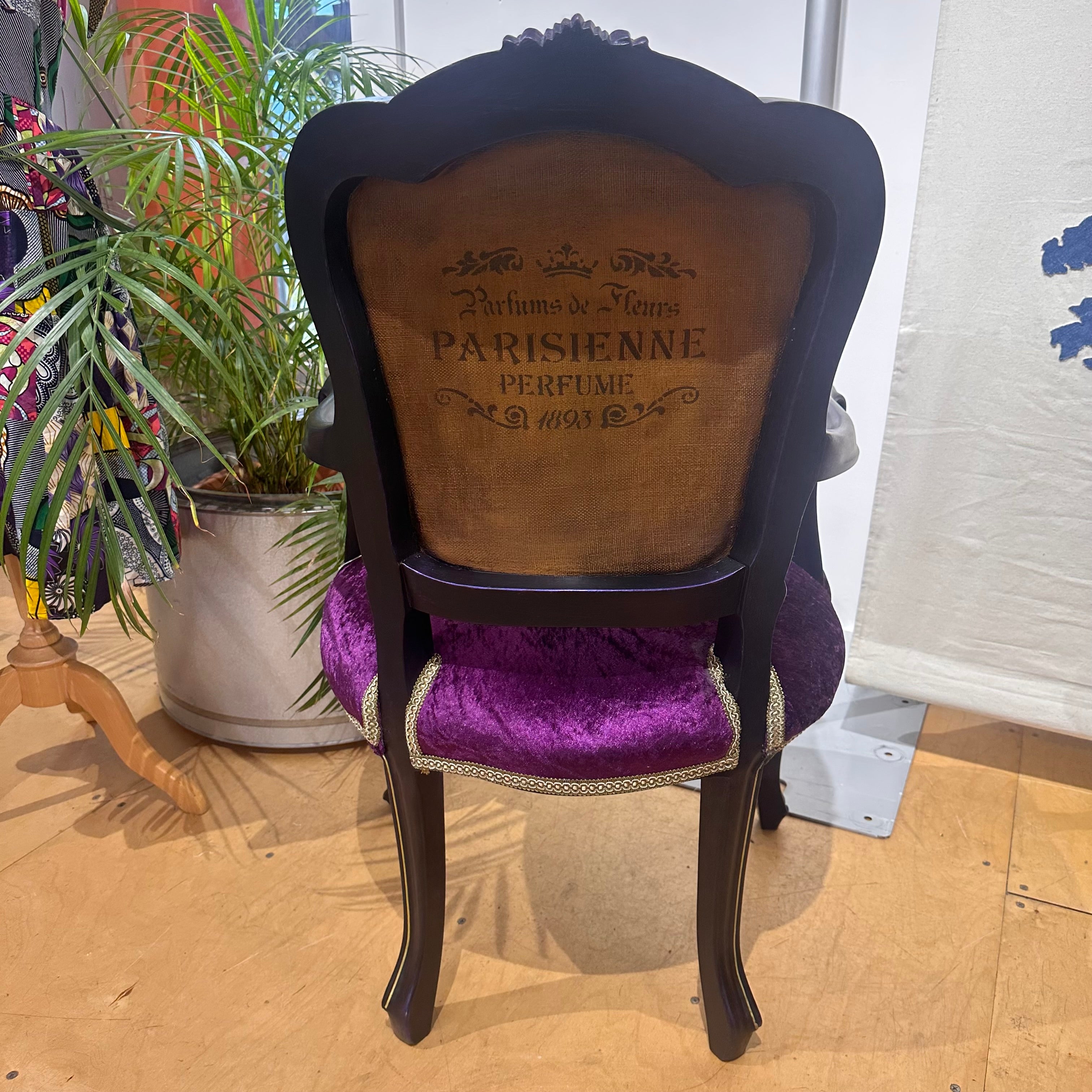 Decorative chair with purple cushion and wooden backrest featuring 'Parisienne' branding.