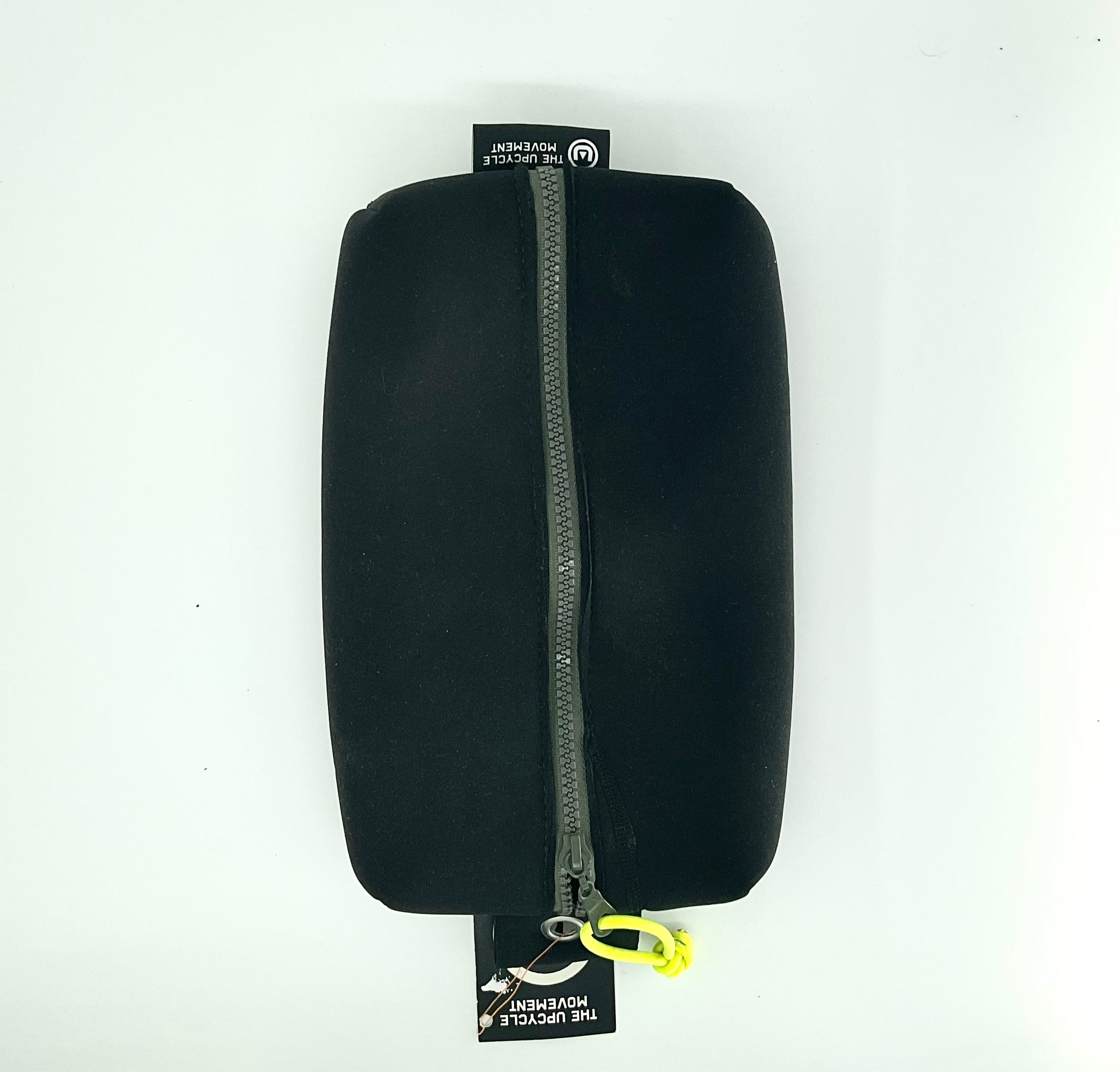 A black case with a zipper, made from upcycled materials, with a yellow tag and a label that includes the text 'The Upcycle Movement'.