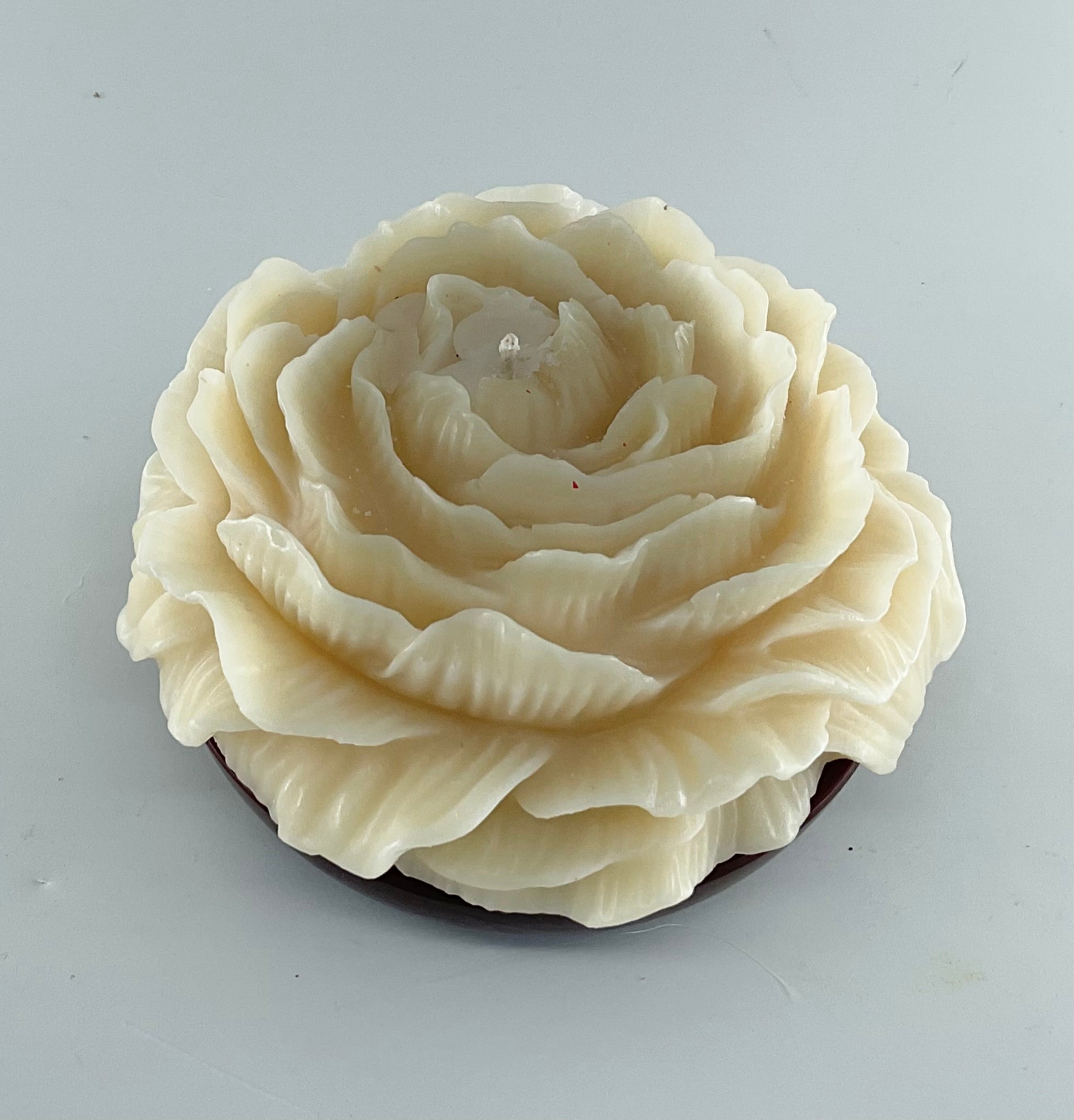 White rose-shaped soap on a gray background