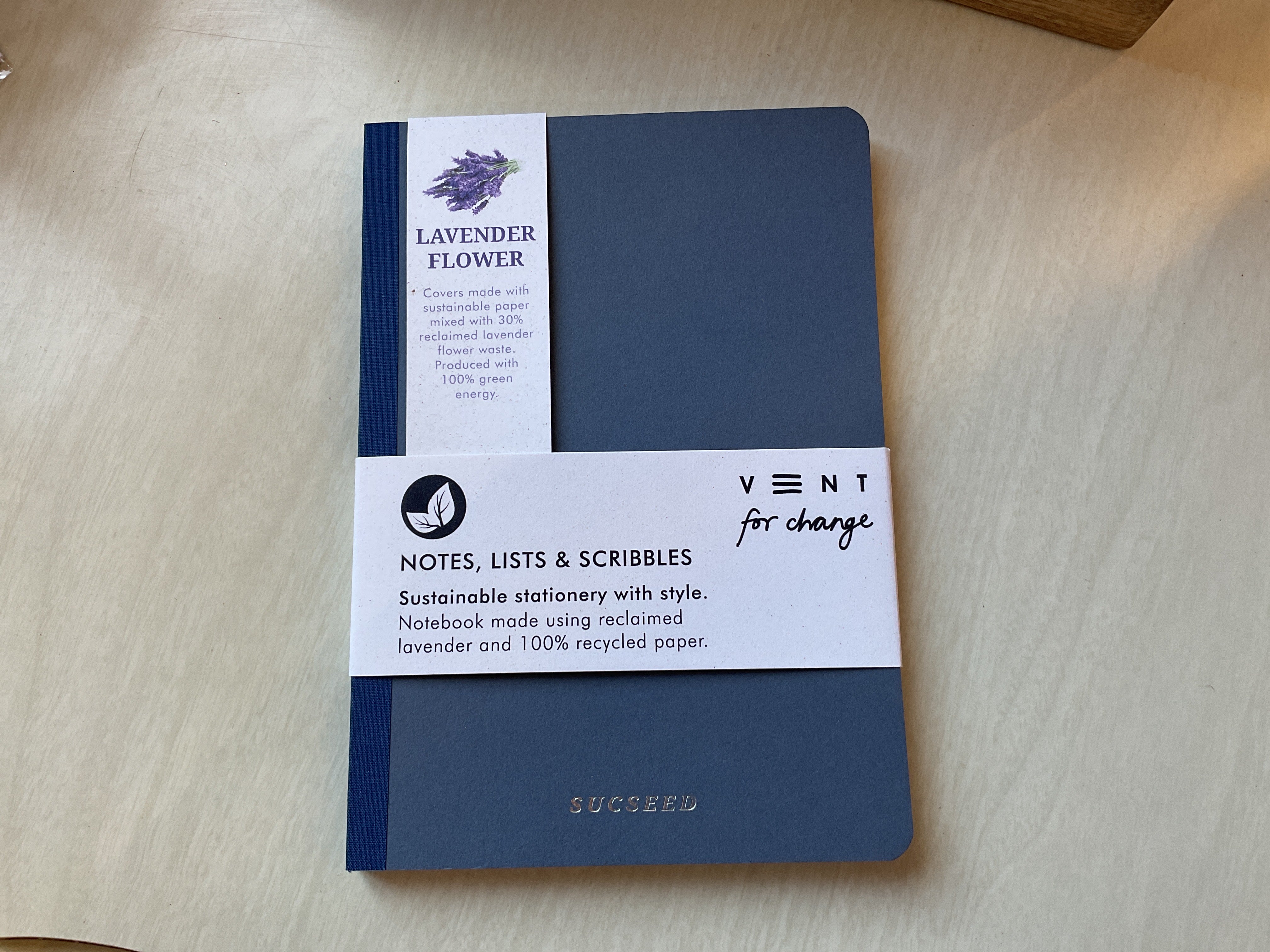 front cover of vent for change notebook, with paper packaging on top of it