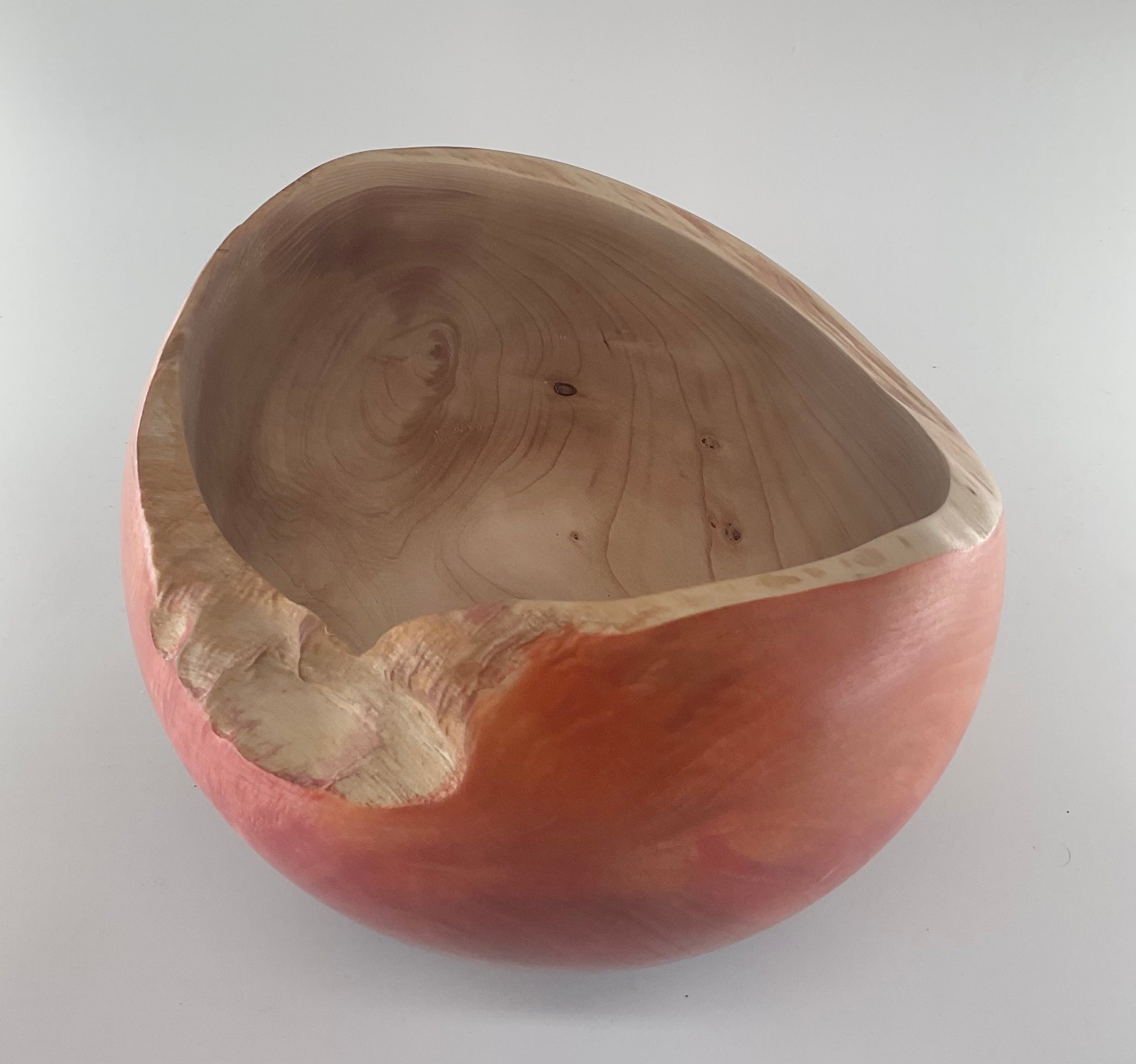 Wooden bowl with a natural edge on a white background