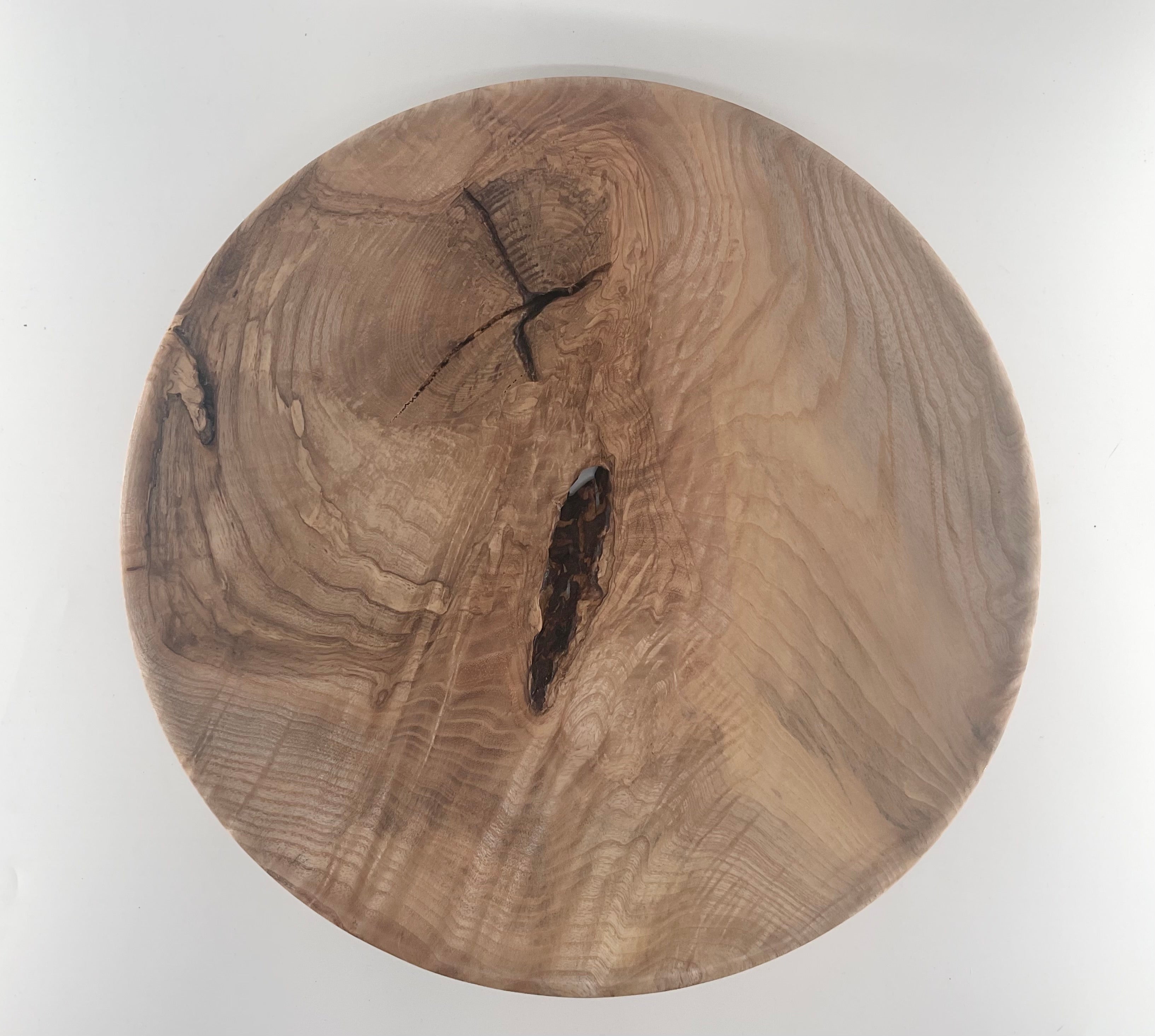 Round plate with a natural grain pattern on a white background
