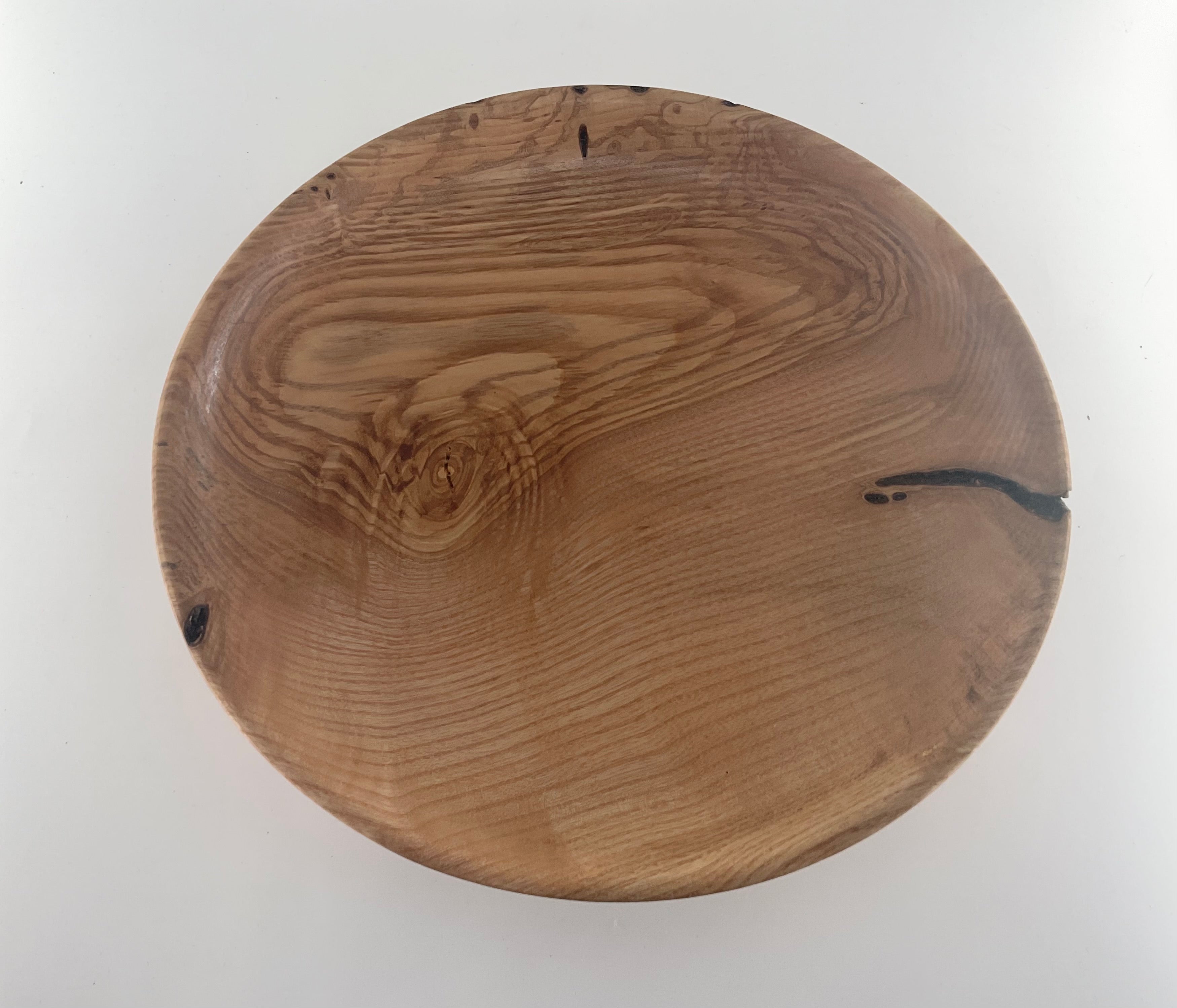 Wooden plate with a natural grain pattern on a white background