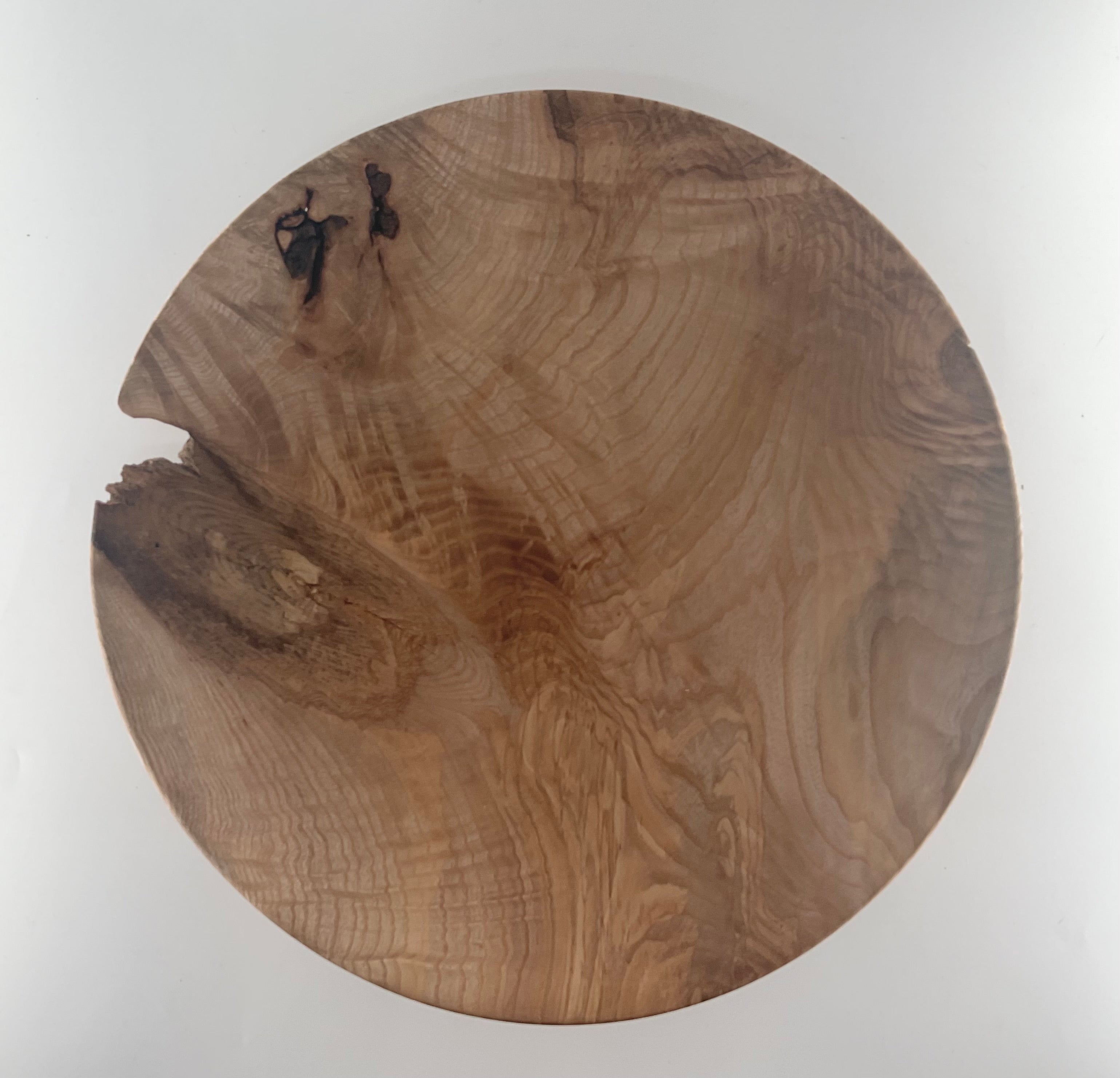Wooden plate with a natural grain pattern on a white background