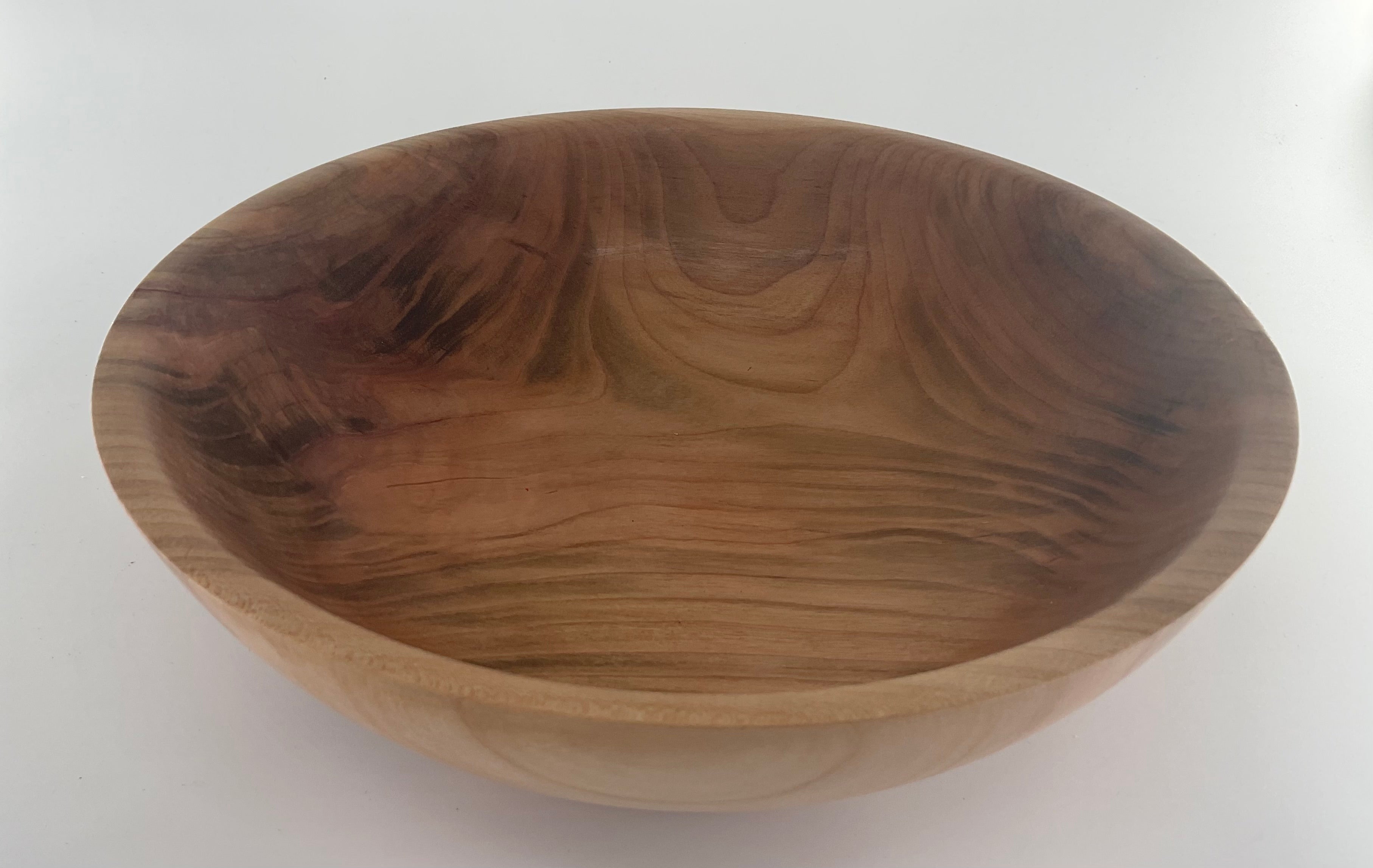 Wooden bowl with a natural finish on a white background