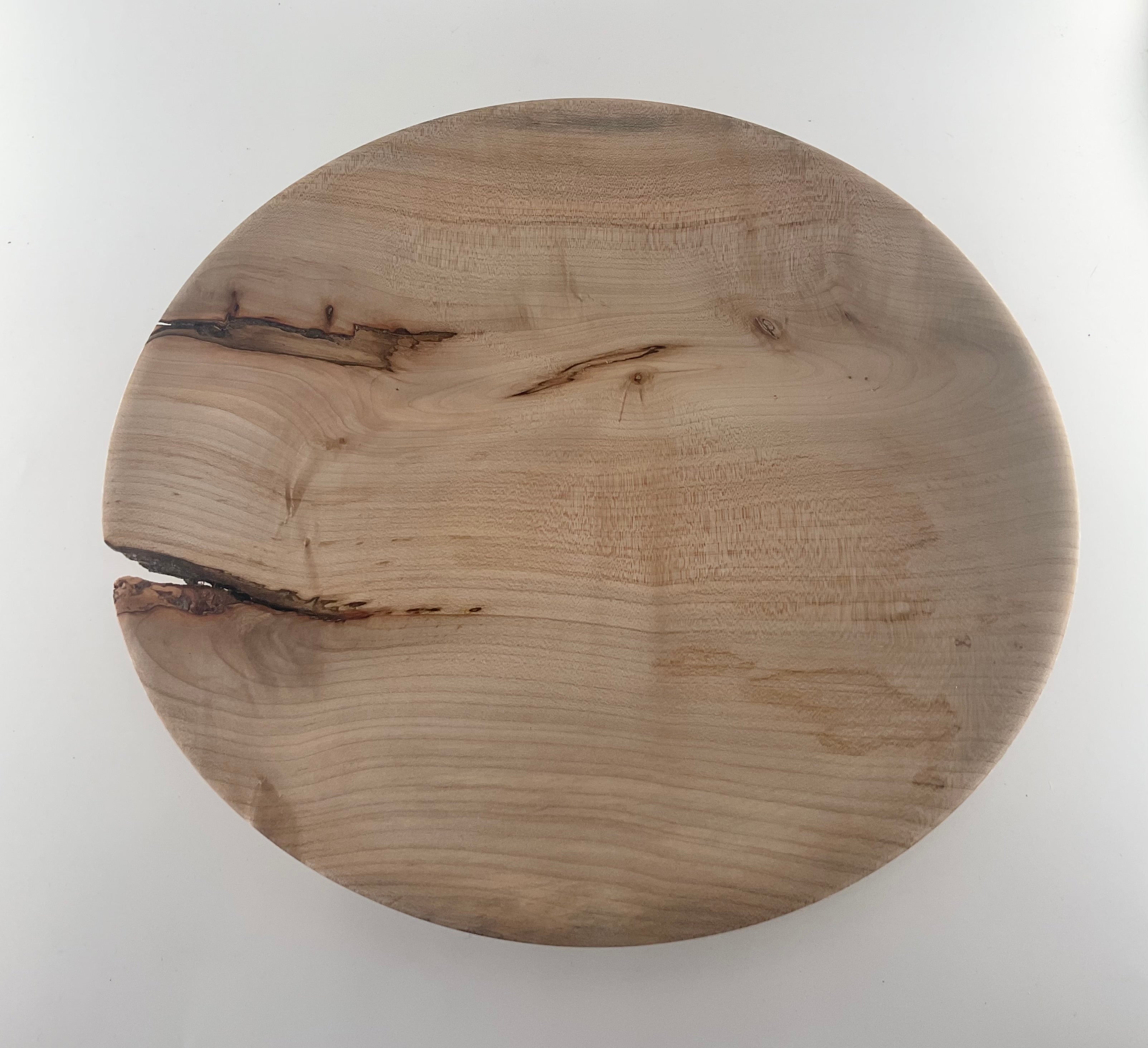 Round wooden plate on a white background