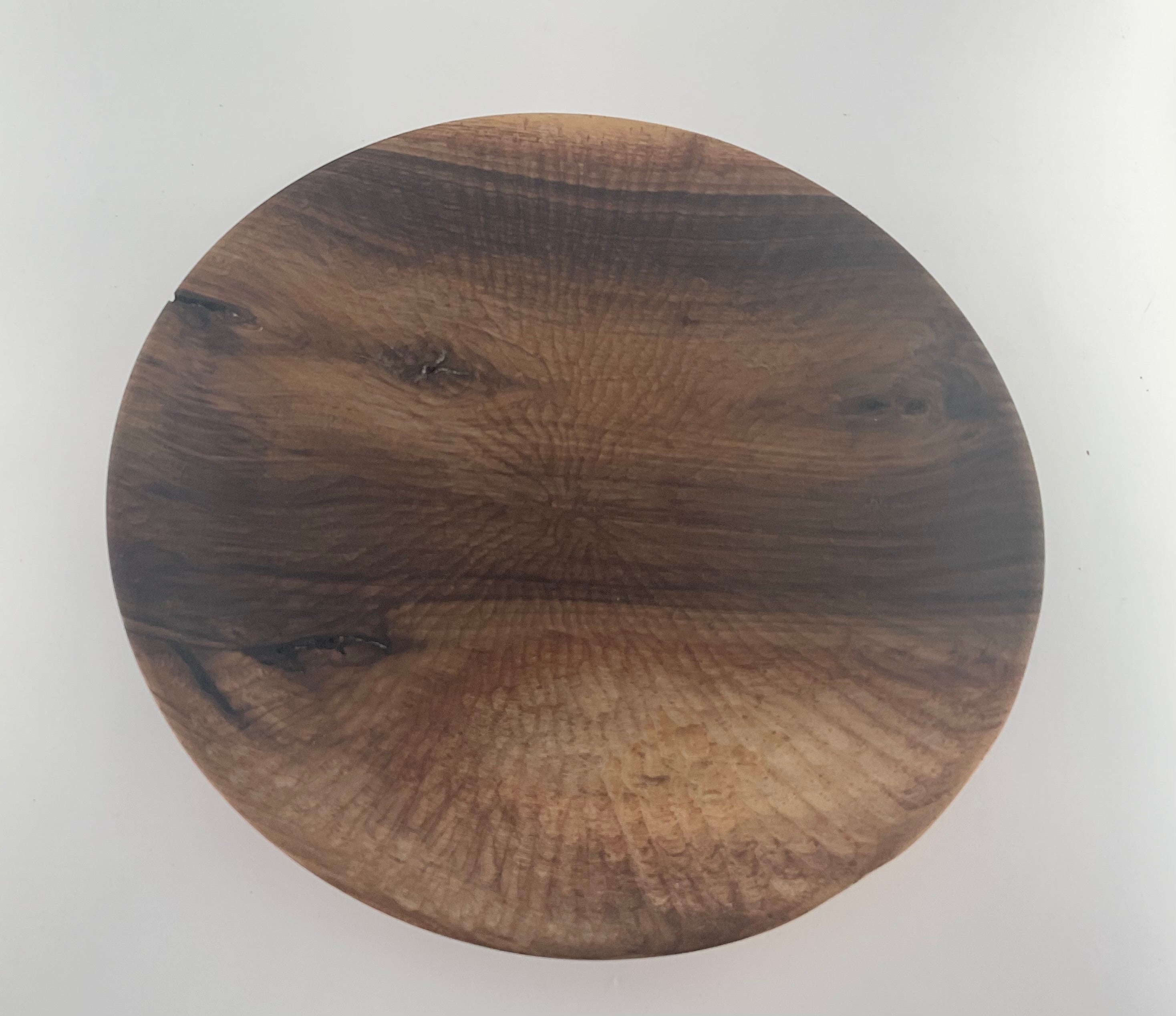 Round wooden plate on a white background