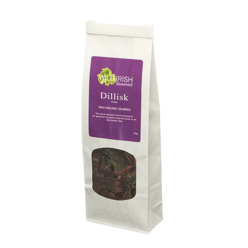 Packaged Wild Irish Seaweed Dillisk in a white bag with a transparent window showing the dark seaweed inside, and purple labeling text.