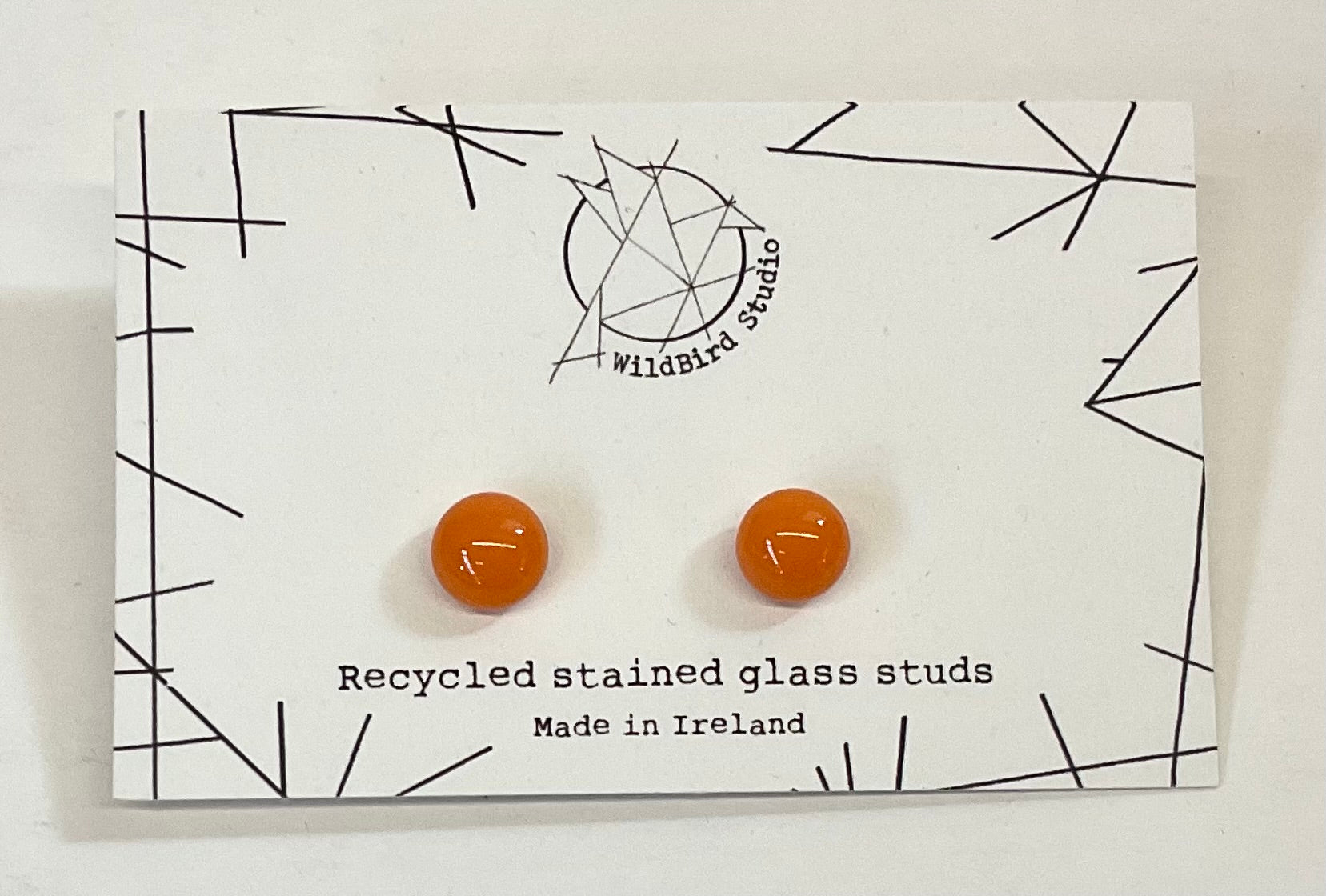Recycled stained glass stud earrings on a WildBird Studio card.