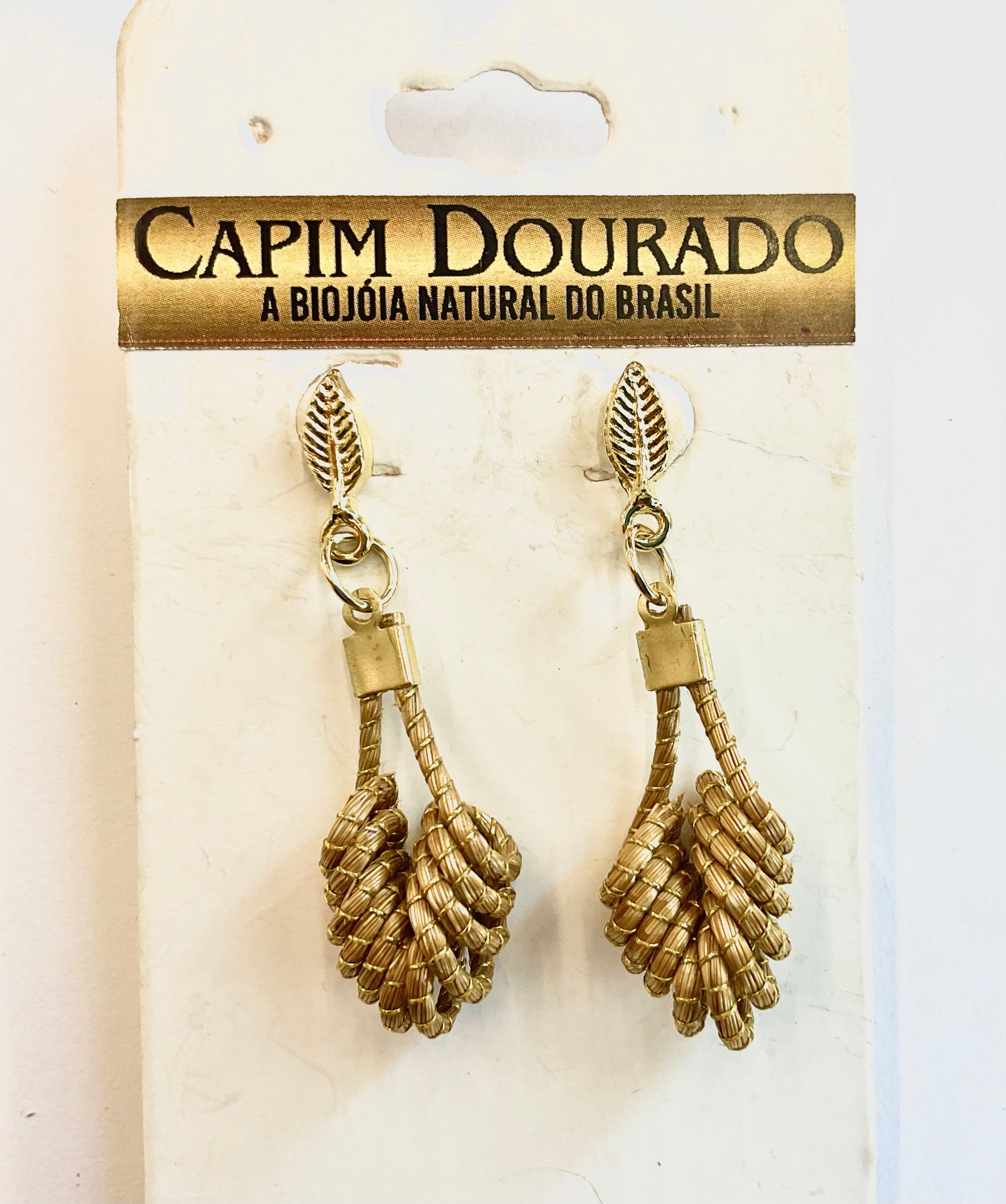 earrings from world design made from naturally golden grass, in a spiral shape with golder leaves at the top