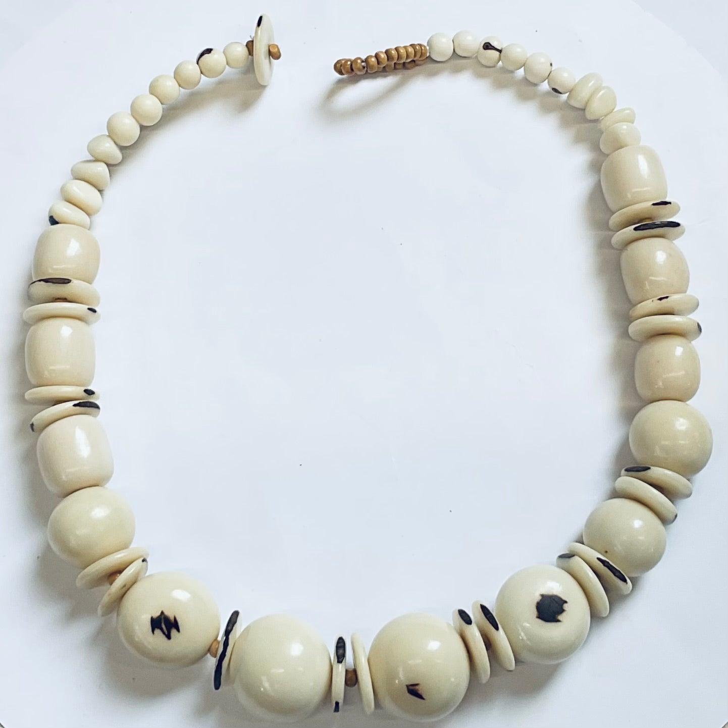 Necklace with large cream-colored beads on a white background