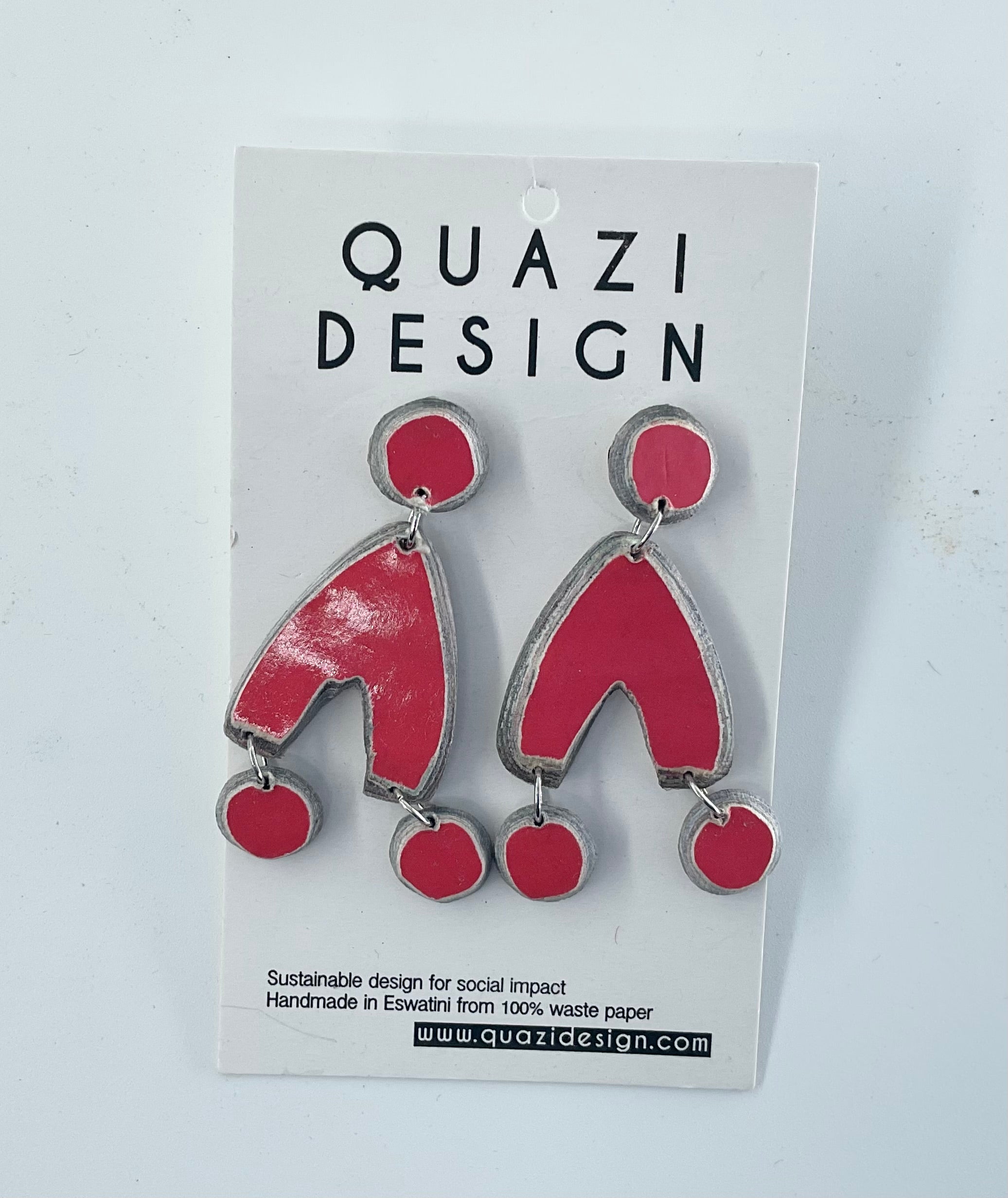 Red and silver earrings on a Quazi Design card with a white background