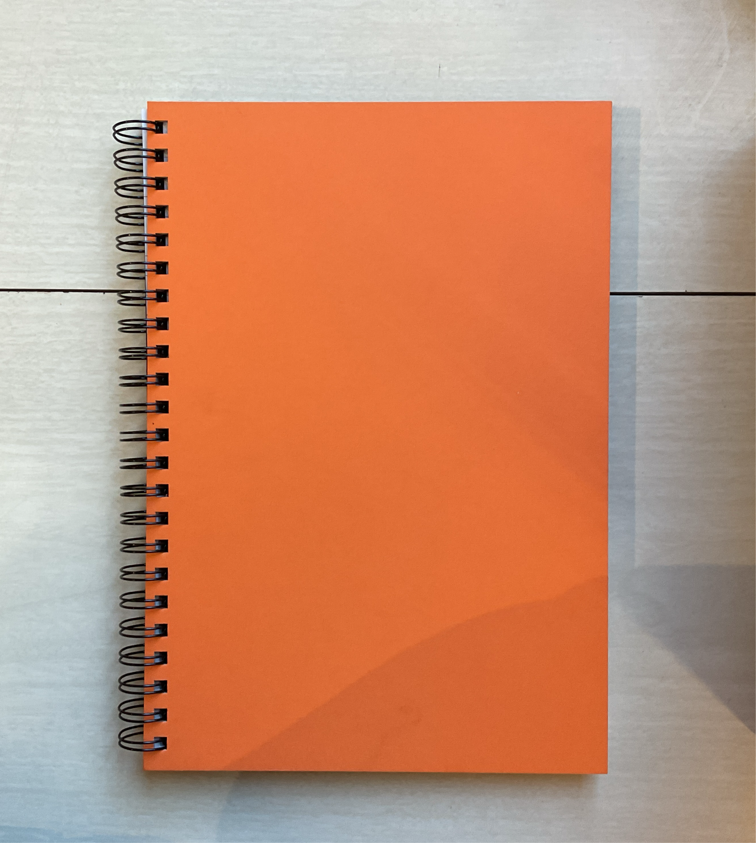 orange spiralbound notebook