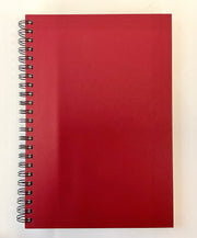 Red spiral-bound notebook on a white background